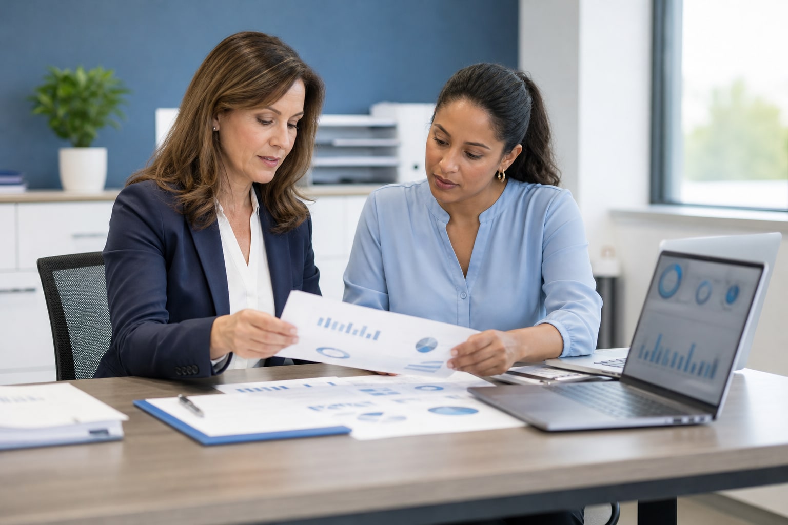 Healthcare practice manager and billing specialist reviewing a revenue-cycle performance report