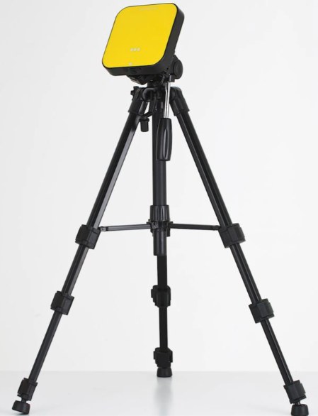 Yellow radon measurement device on a tripod