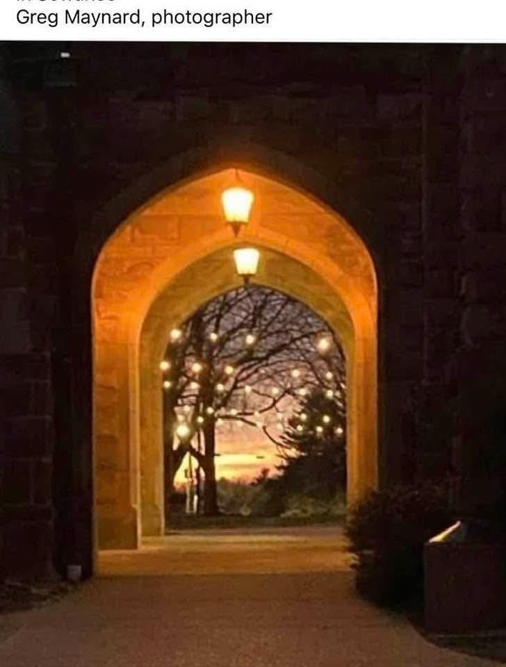 Lighted stone archway at dusk