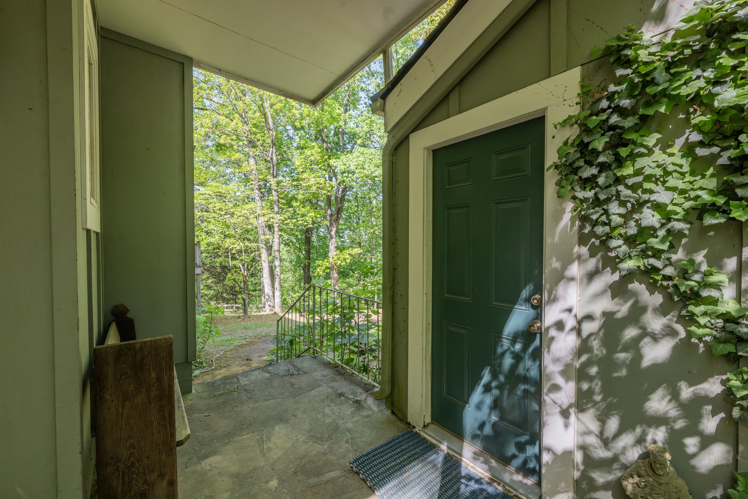 Covered entry at 3442 Sherwood Road with a green front door