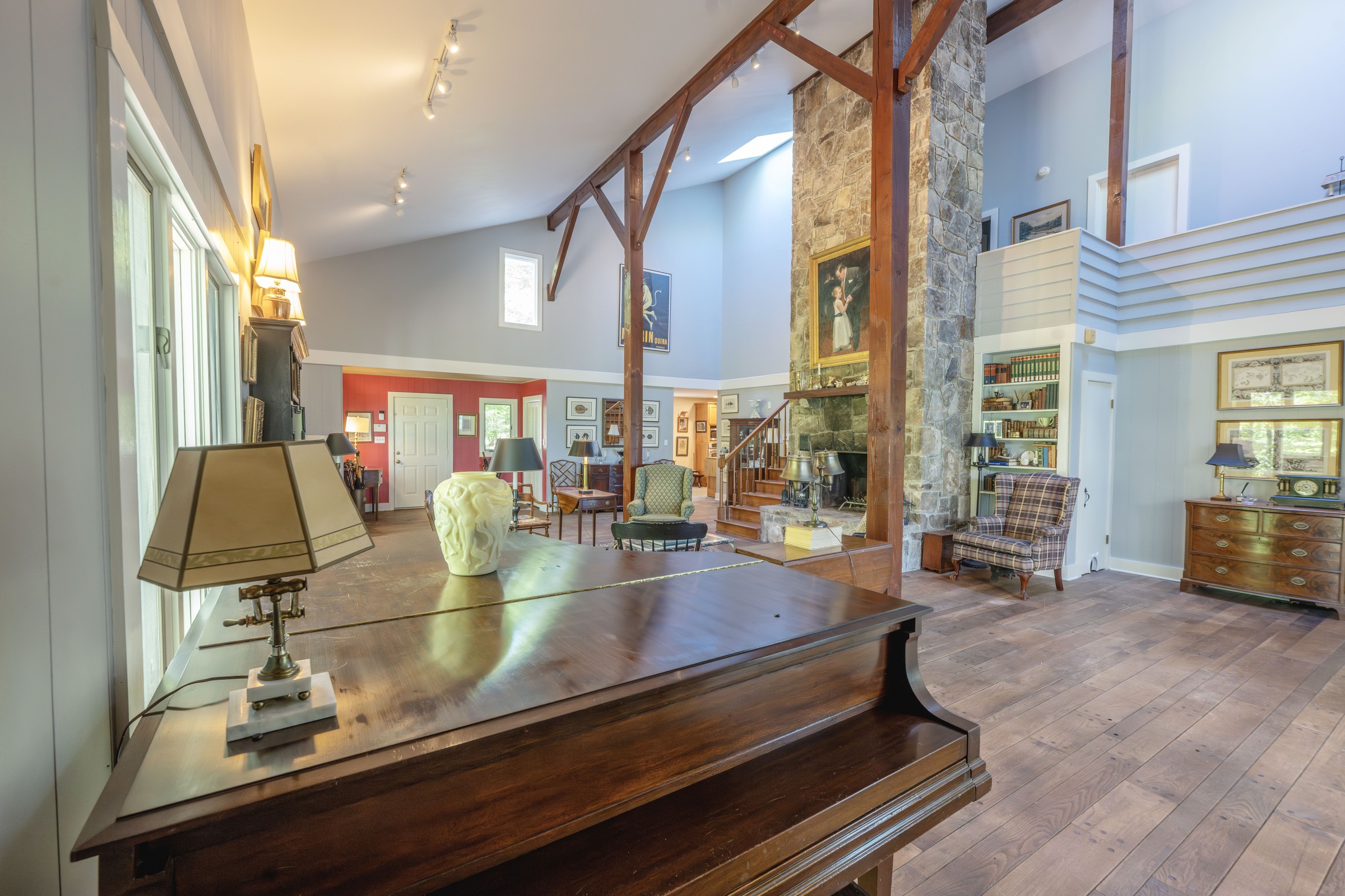 Living room at 3442 Sherwood Road with timber beams and a stone fireplace