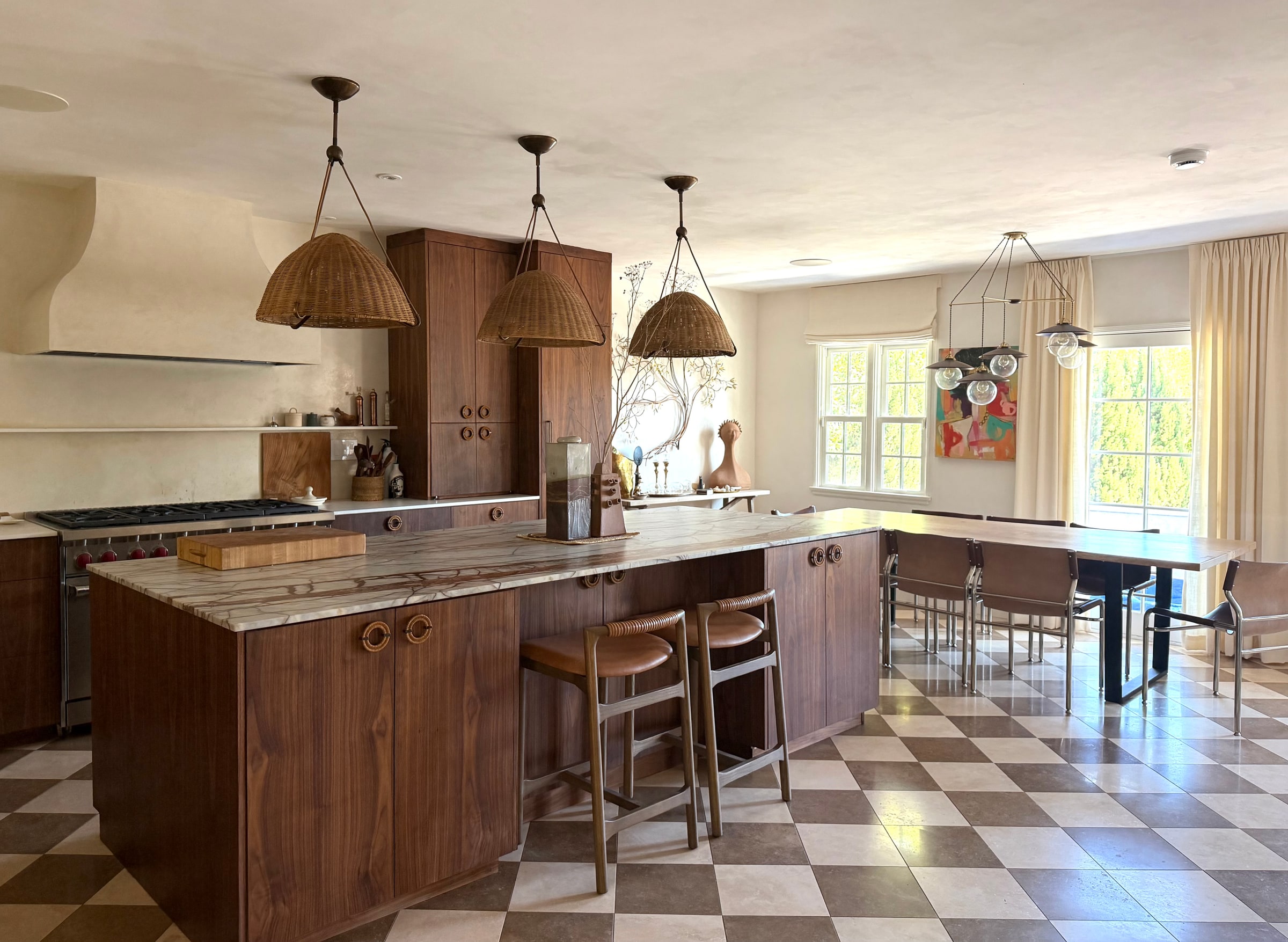 Luxury Los Angeles kitchen and dining interior with walnut cabinetry and sculptural lighting