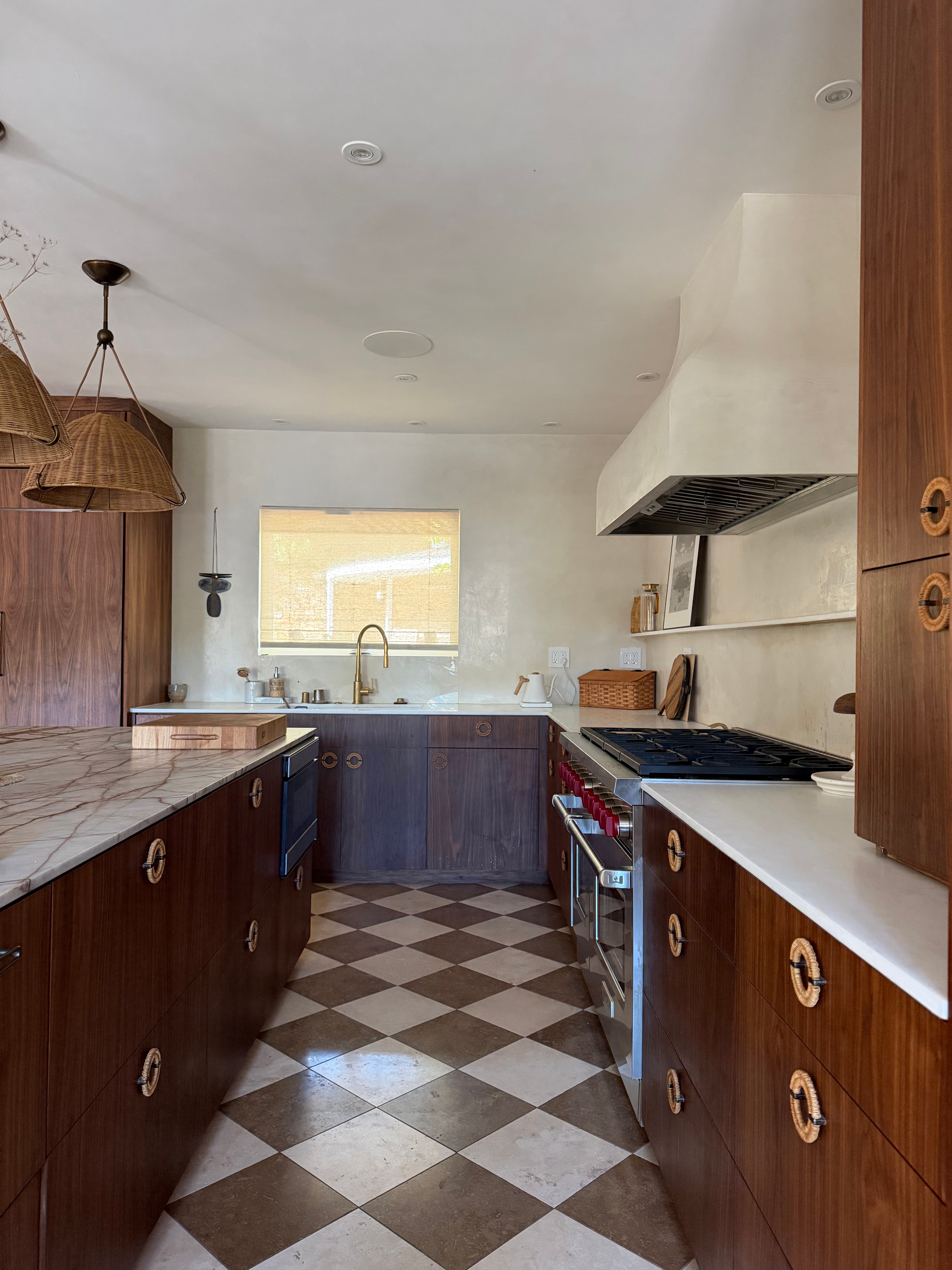 Custom walnut kitchen cabinetry and natural stone in Hollywood Hills Residence