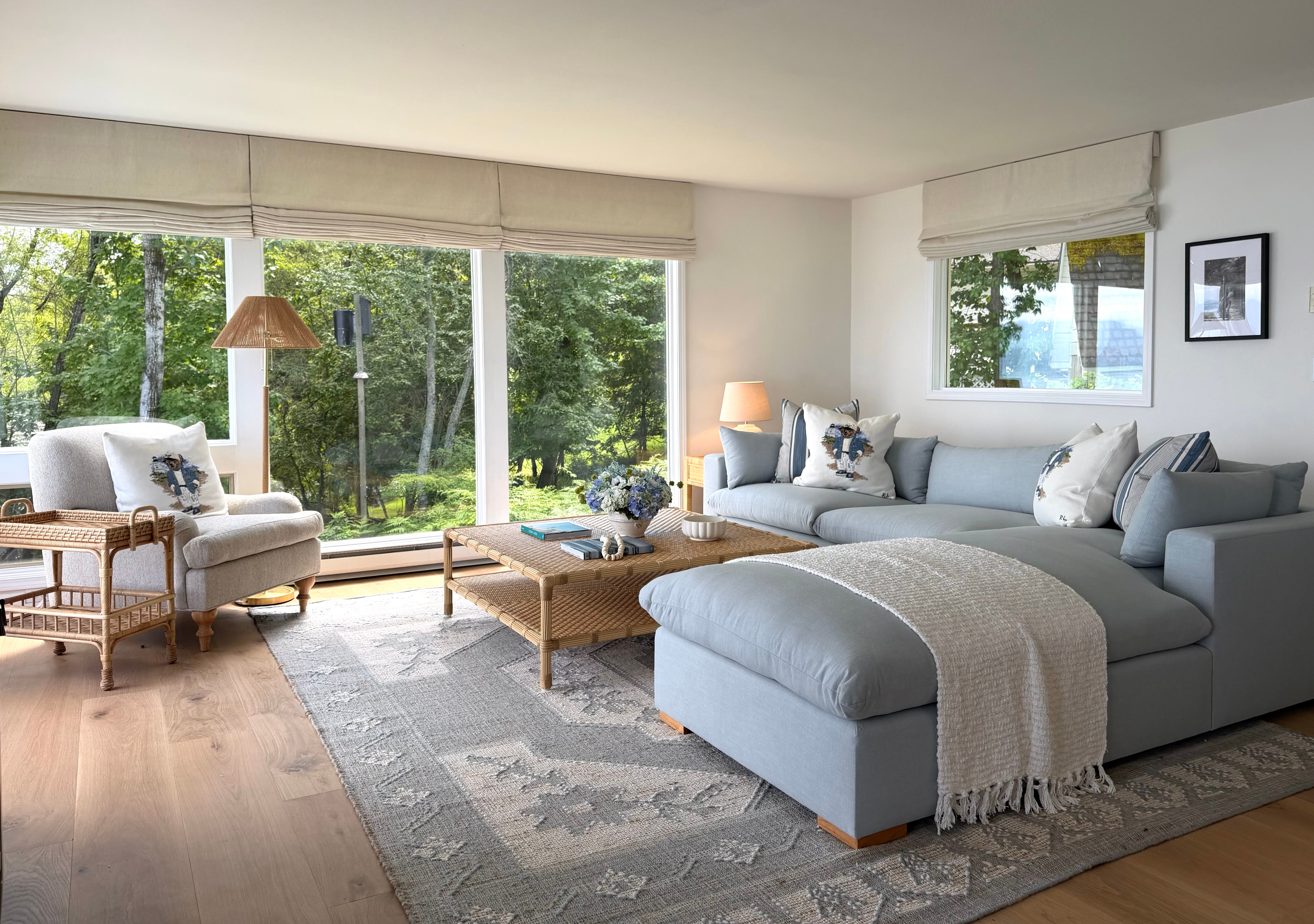 Idaho Lakeside Retreat living room with a pale blue sectional, woven rattan, and soft natural light