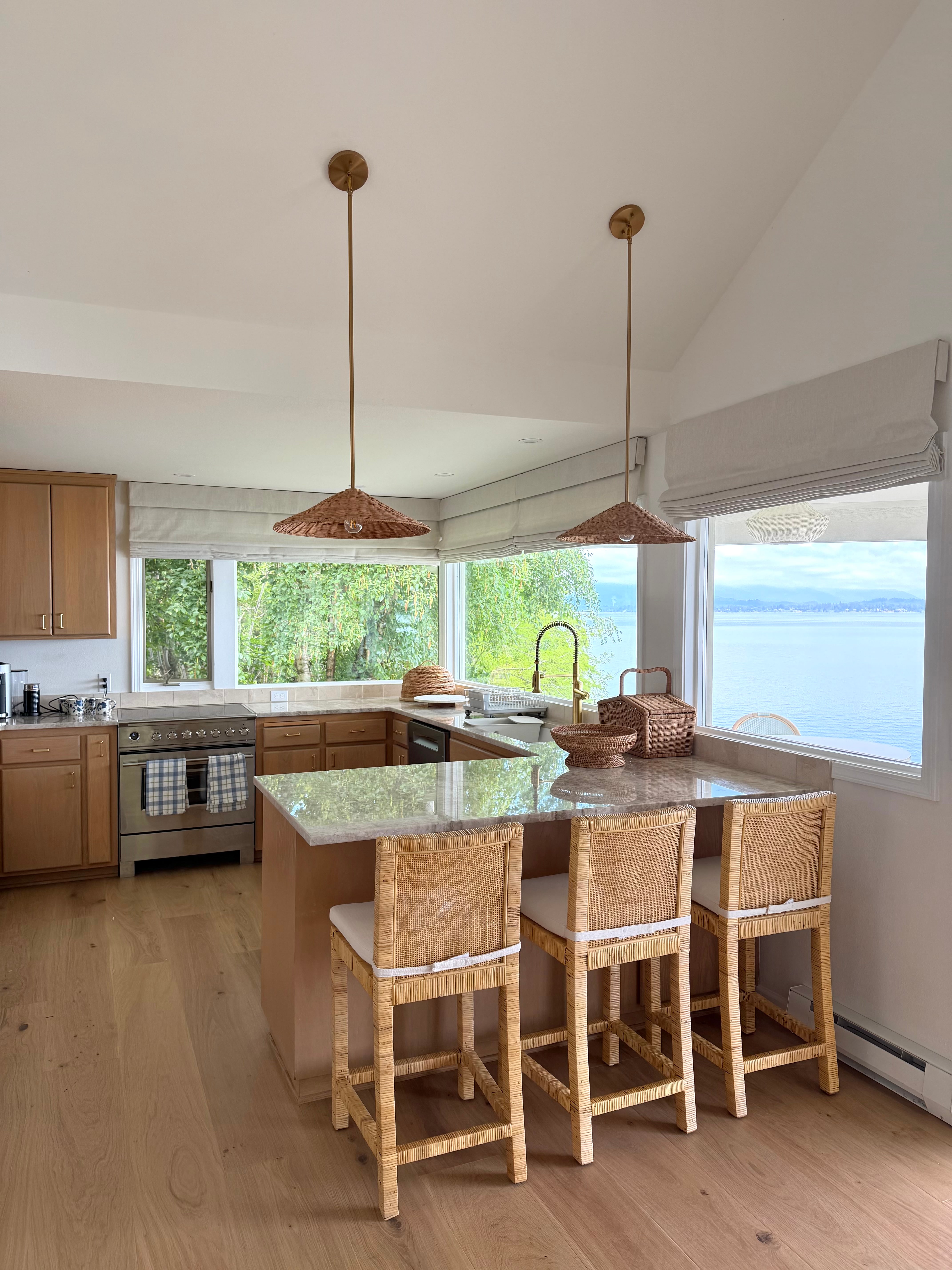 Idaho Lakeside Retreat kitchen with woven counter stools, rattan pendant lights, and lake views