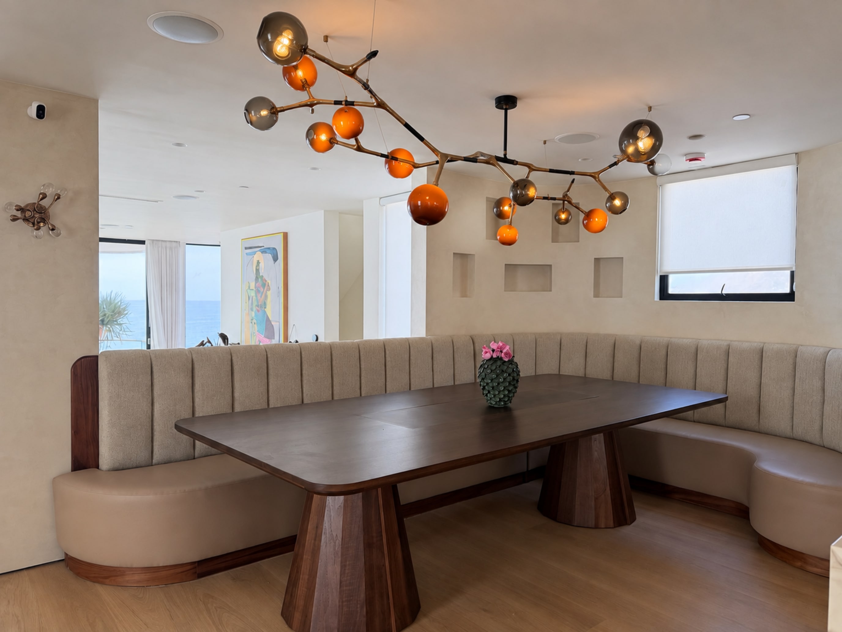 Inviting dining room with sculptural chandelier, pale stone, and considered furnishings