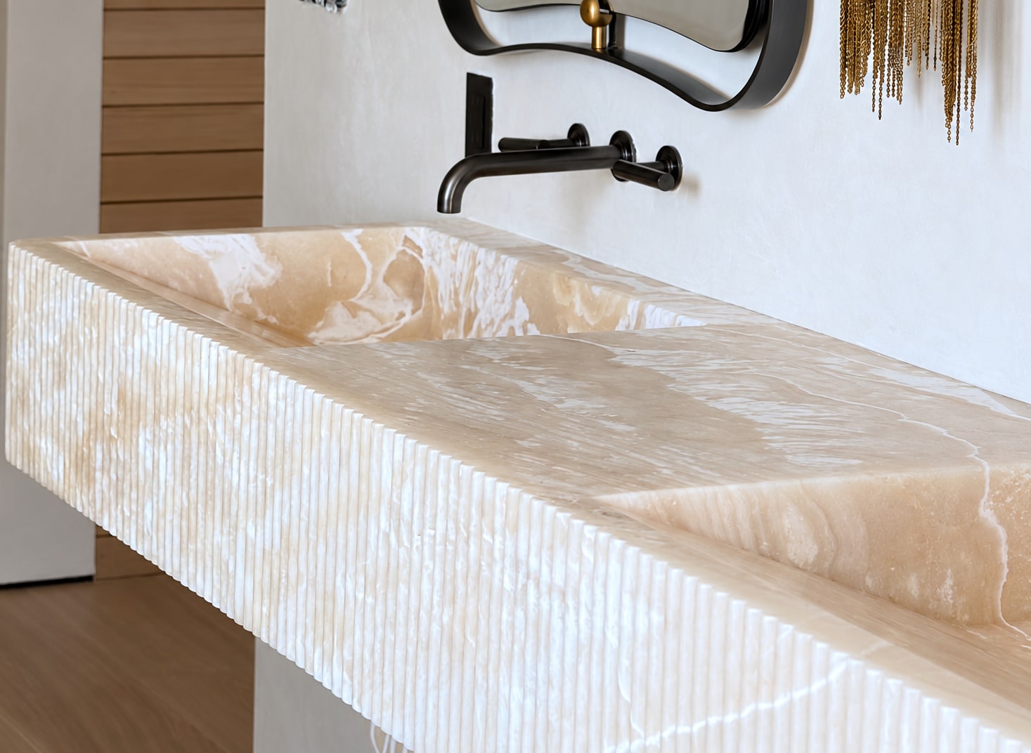 Bespoke fluted onyx double basin designed by The R Creative for the Malibu primary bathroom