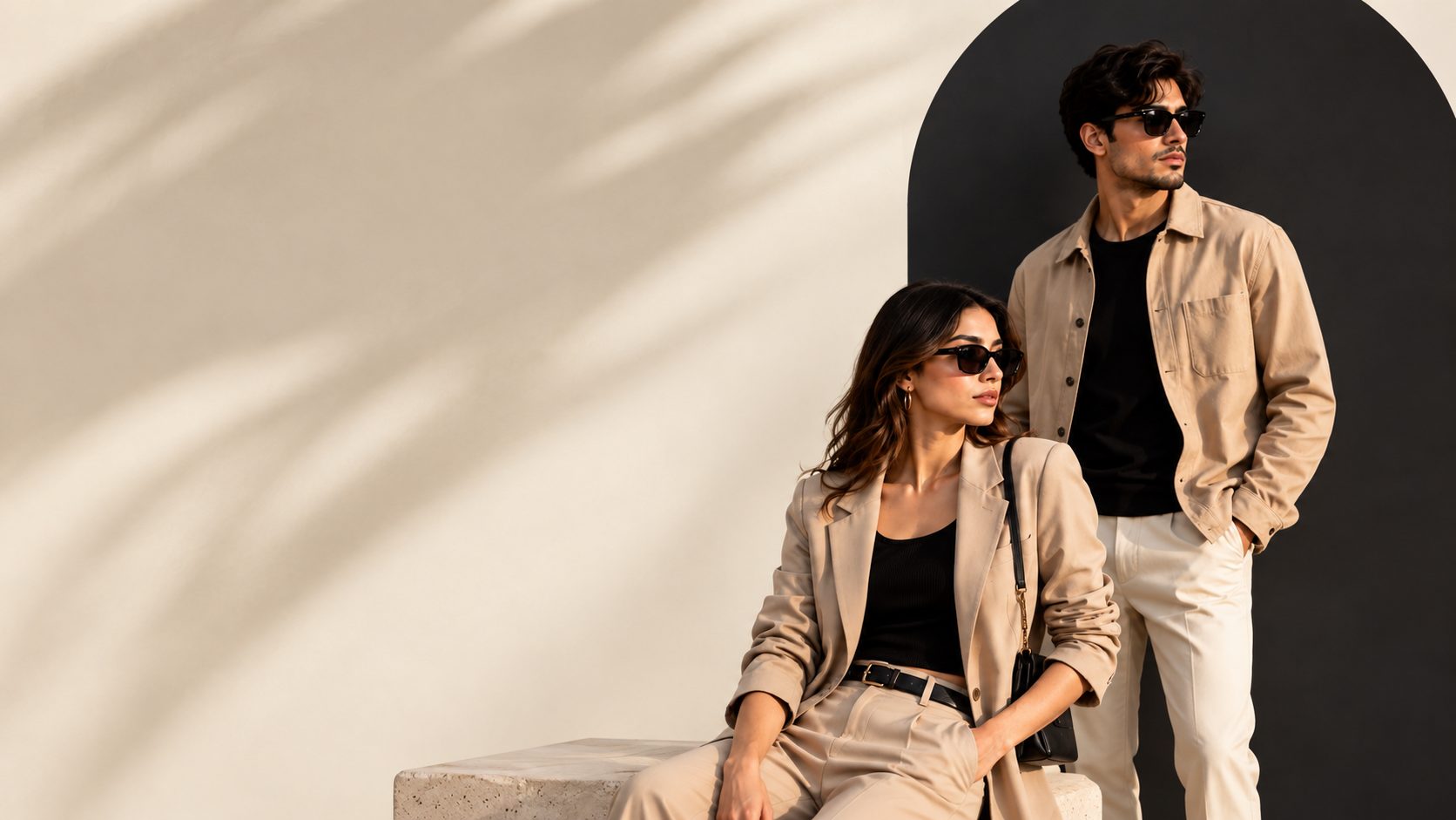 Two models wearing beige tailoring in warm sunlight