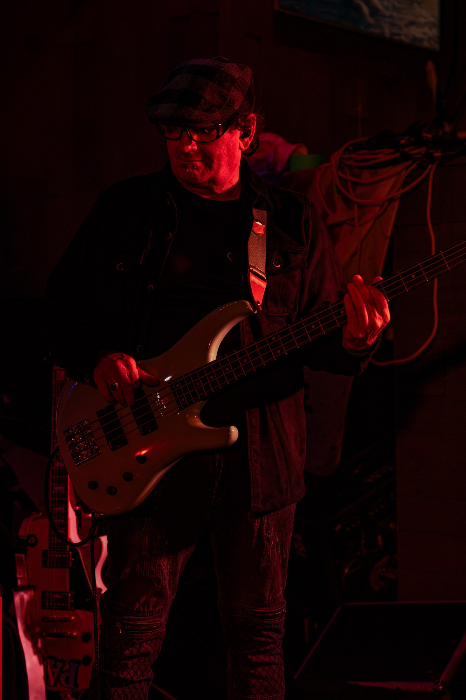 Guitarist playing under red stage lights