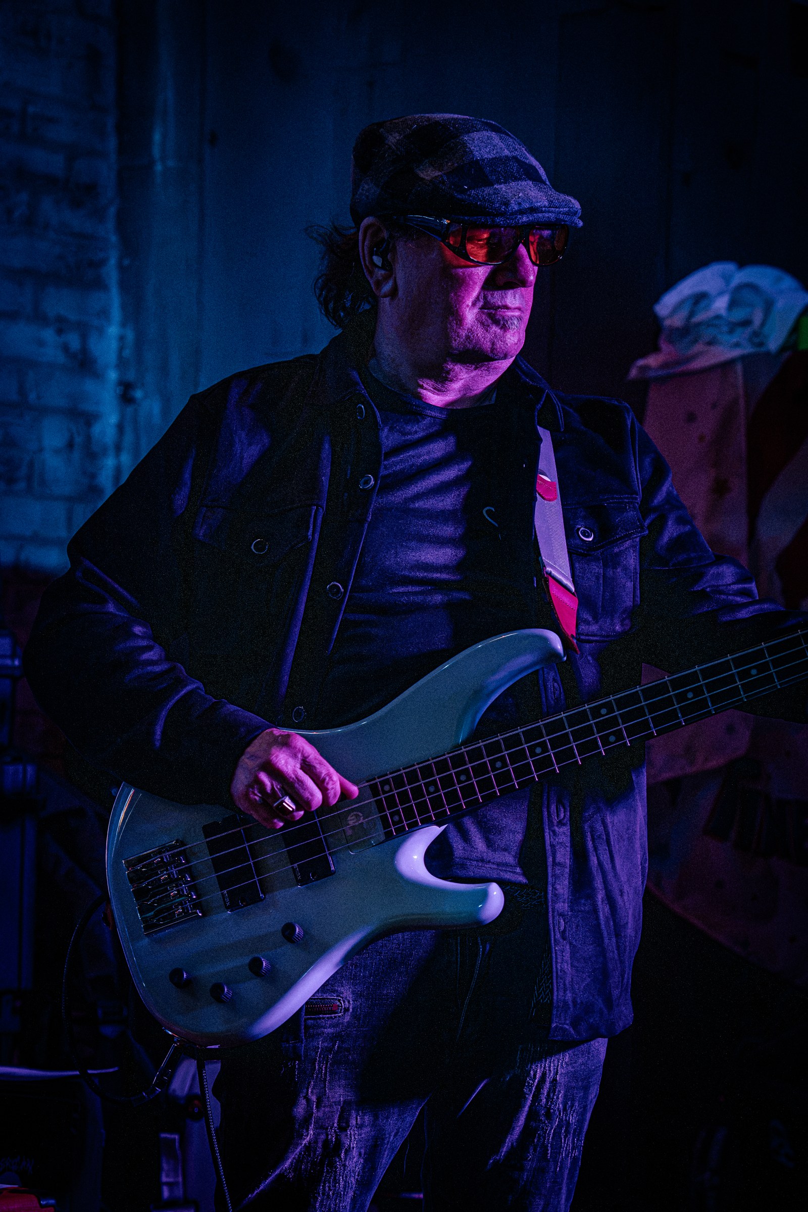 Bassist playing under blue stage lights