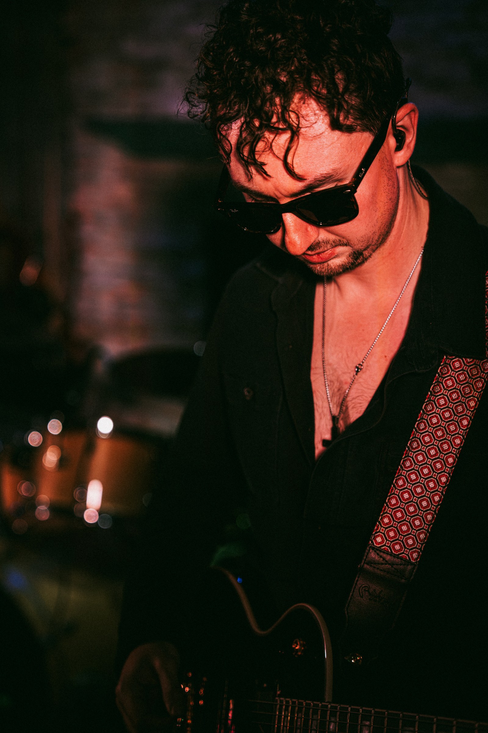Guitarist looking down at his guitar during a performance