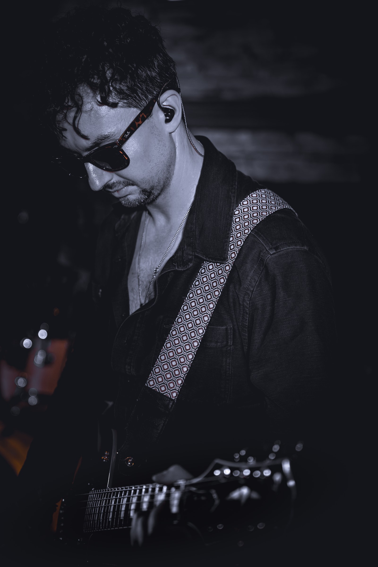 Black-and-white portrait of a guitarist performing
