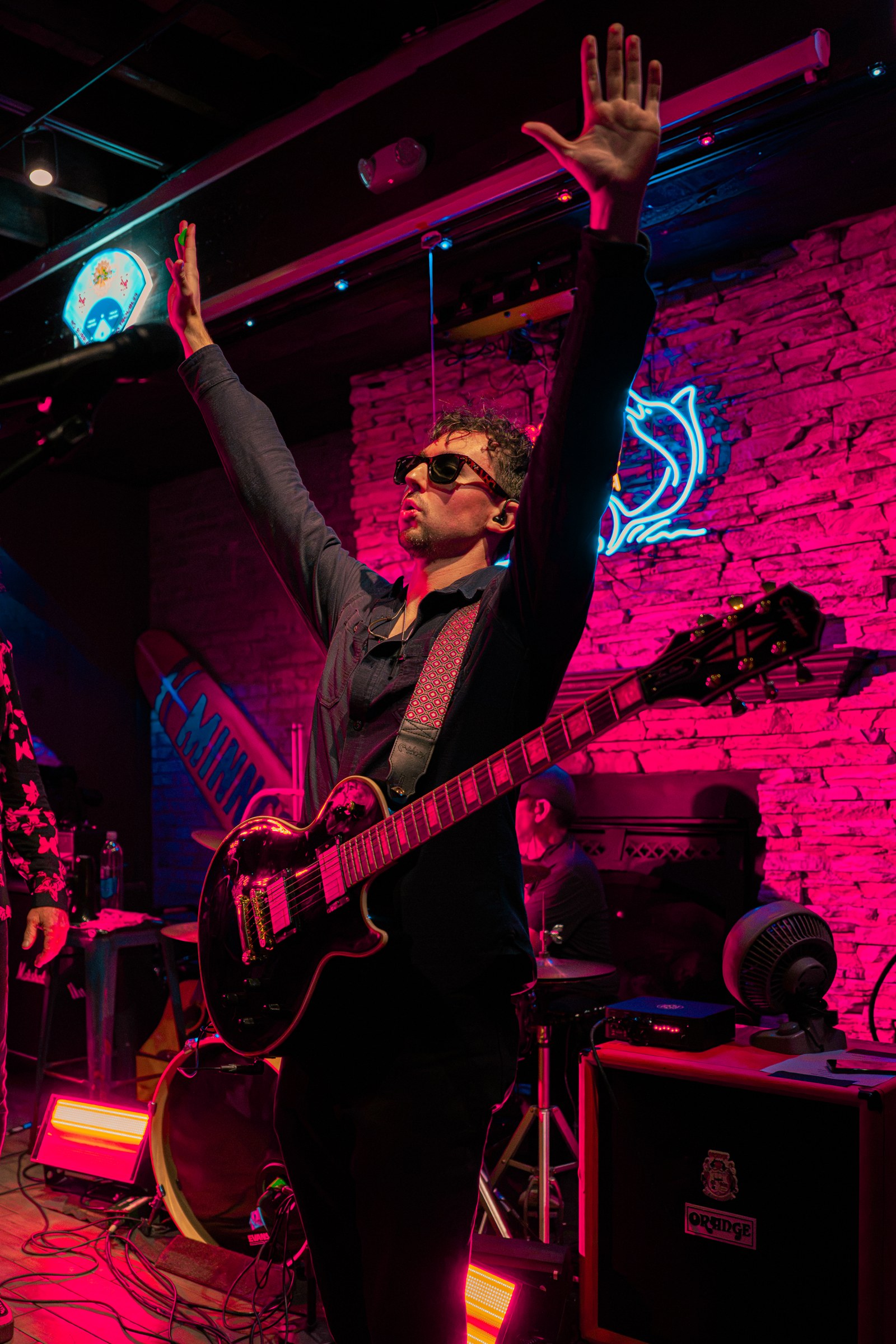 Guitarist raising his arm above the stage