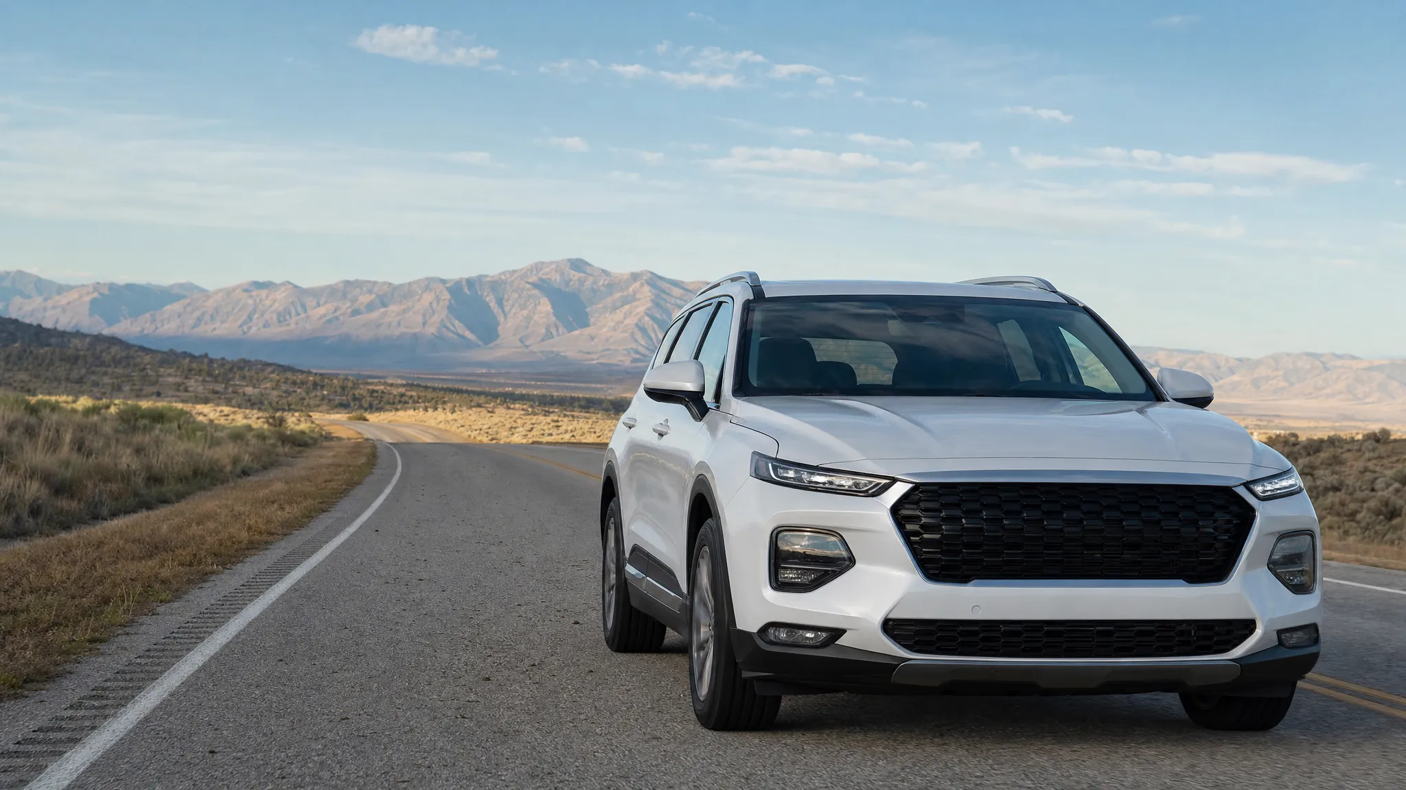 White SUV driving on an open mountain road with a clear windshield