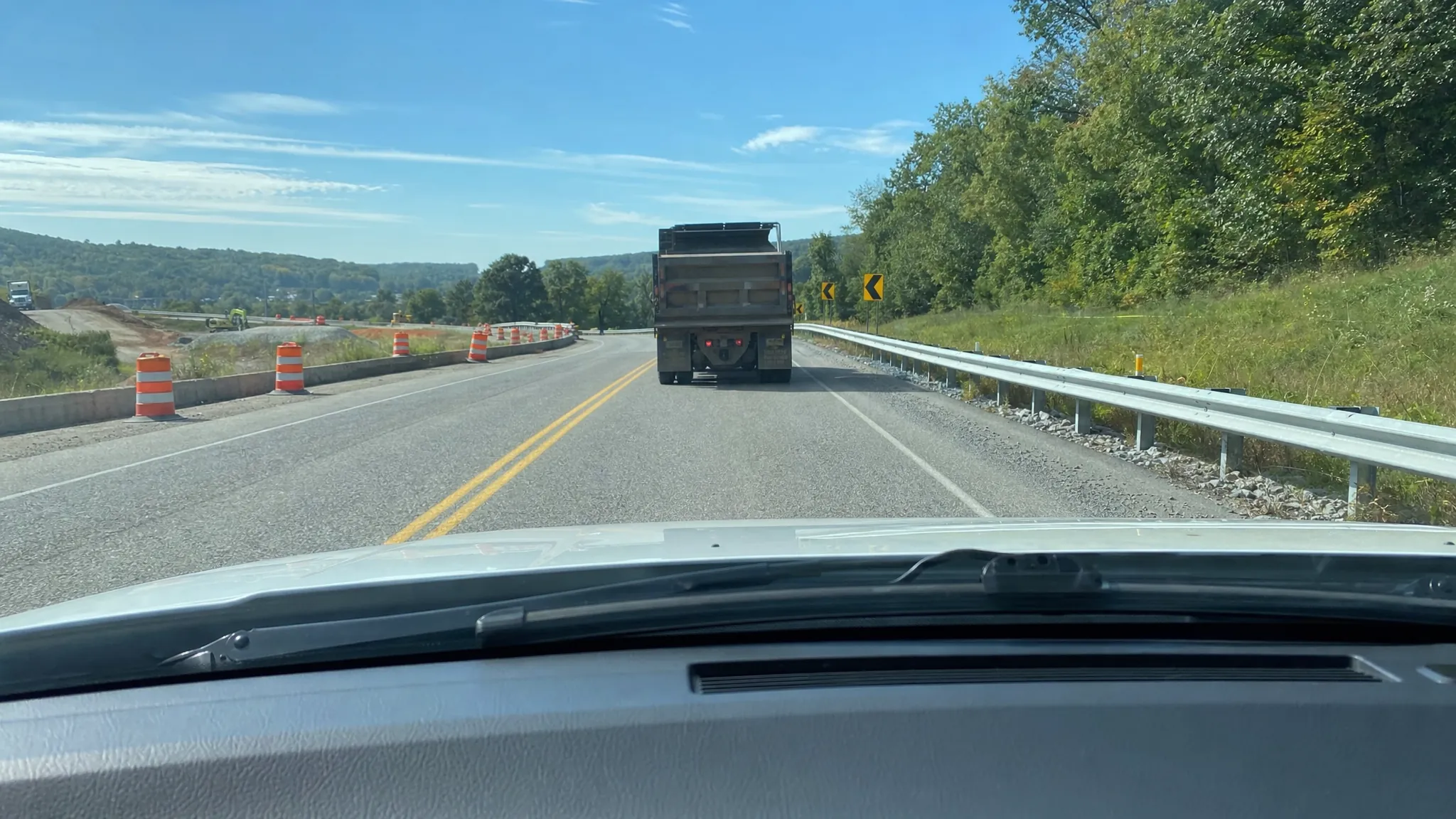 Driver view through a windshield behind a truck in a road construction zone