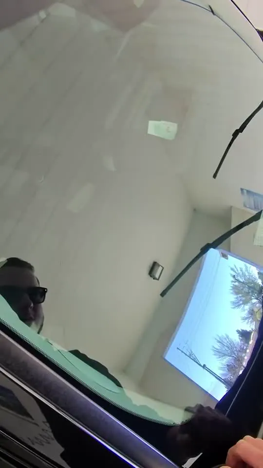 Speaker inspecting a windshield film on a truck