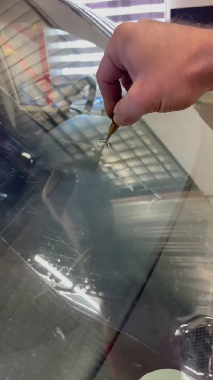 Close-up protective-surface demonstration on automotive glass