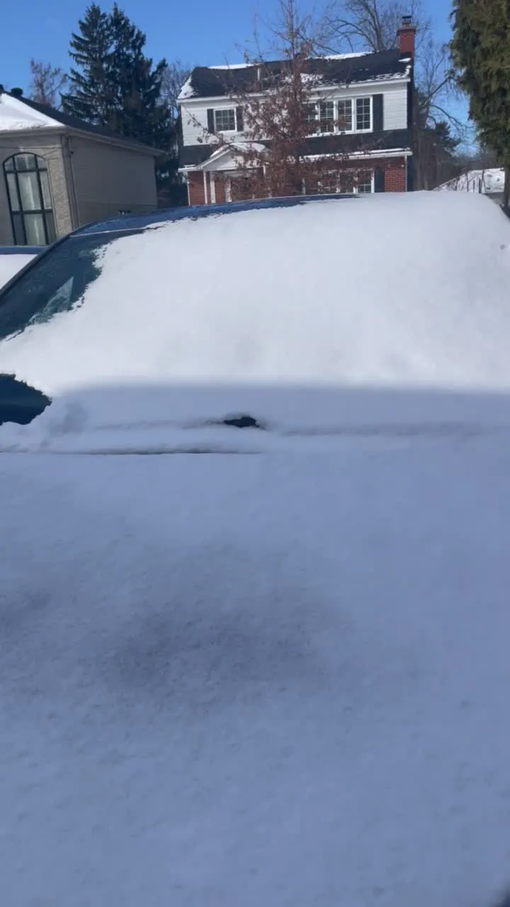 Snow-covered vehicle windshield in winter conditions