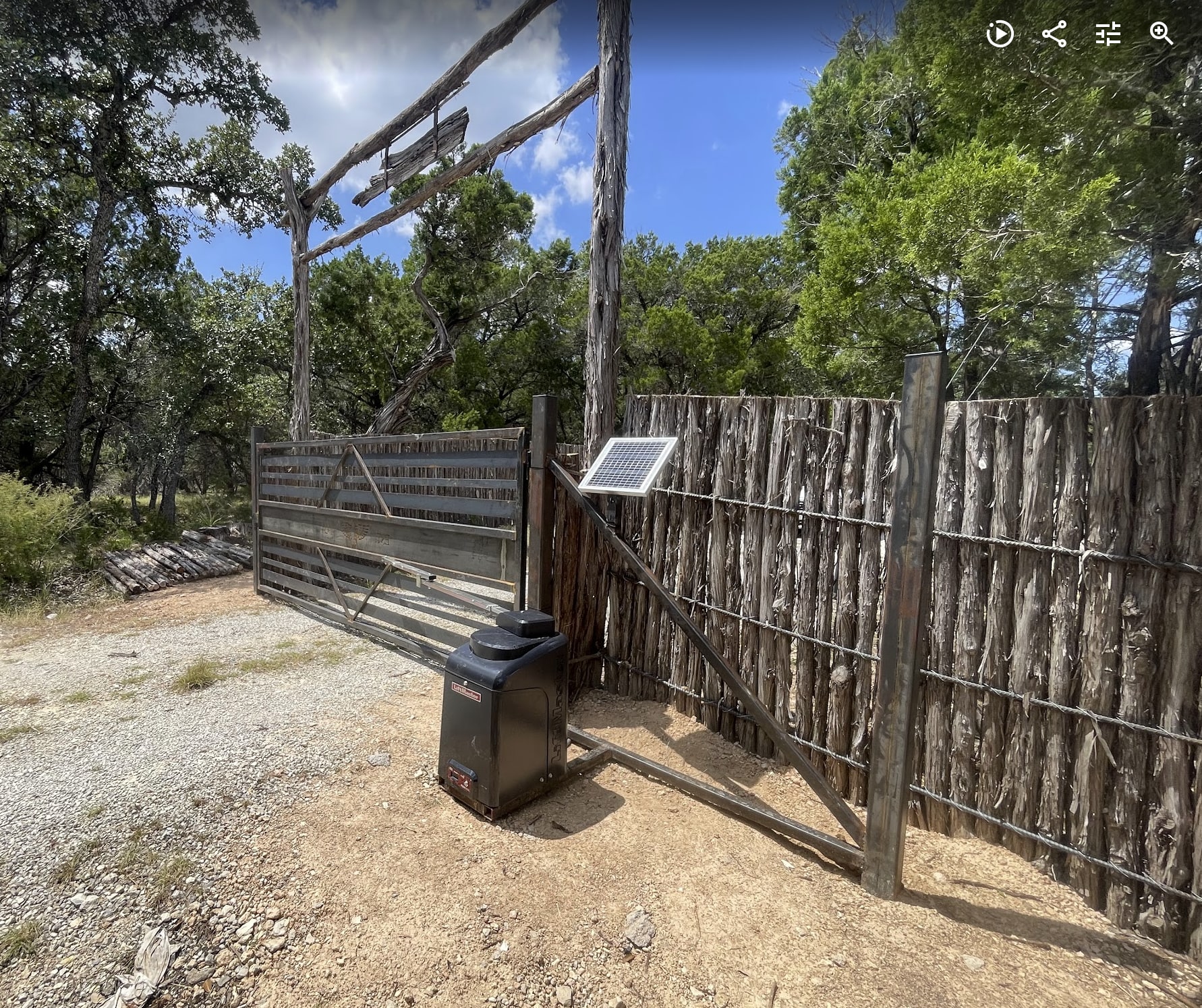 Solar-powered automatic gate operator at a Hill Country entrance