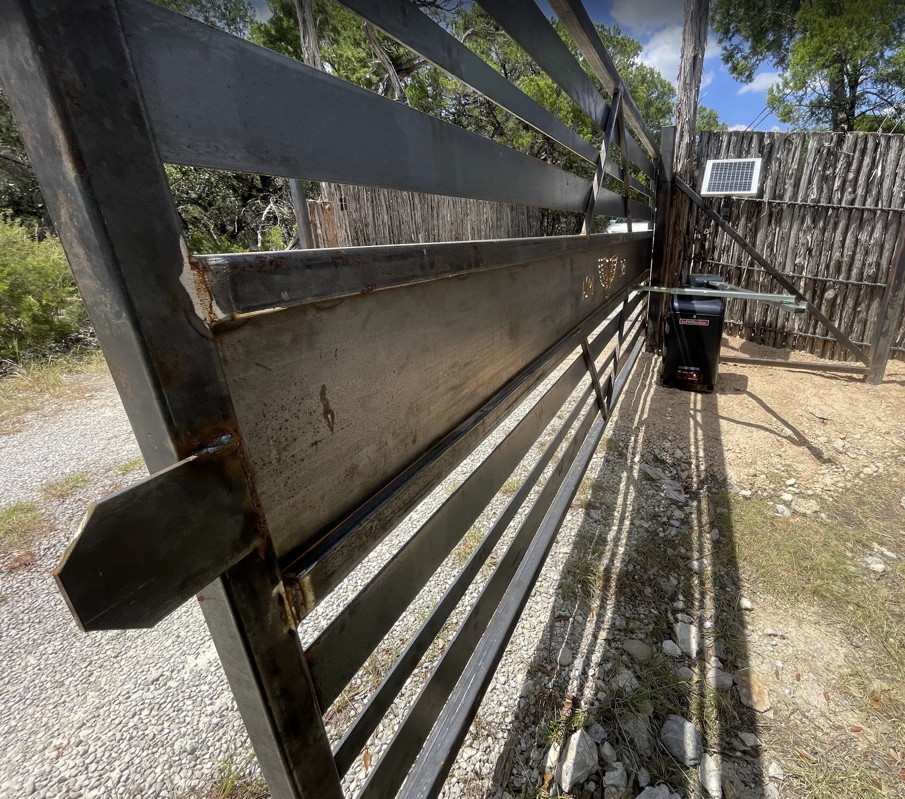 Automatic driveway gate with solar-powered operator