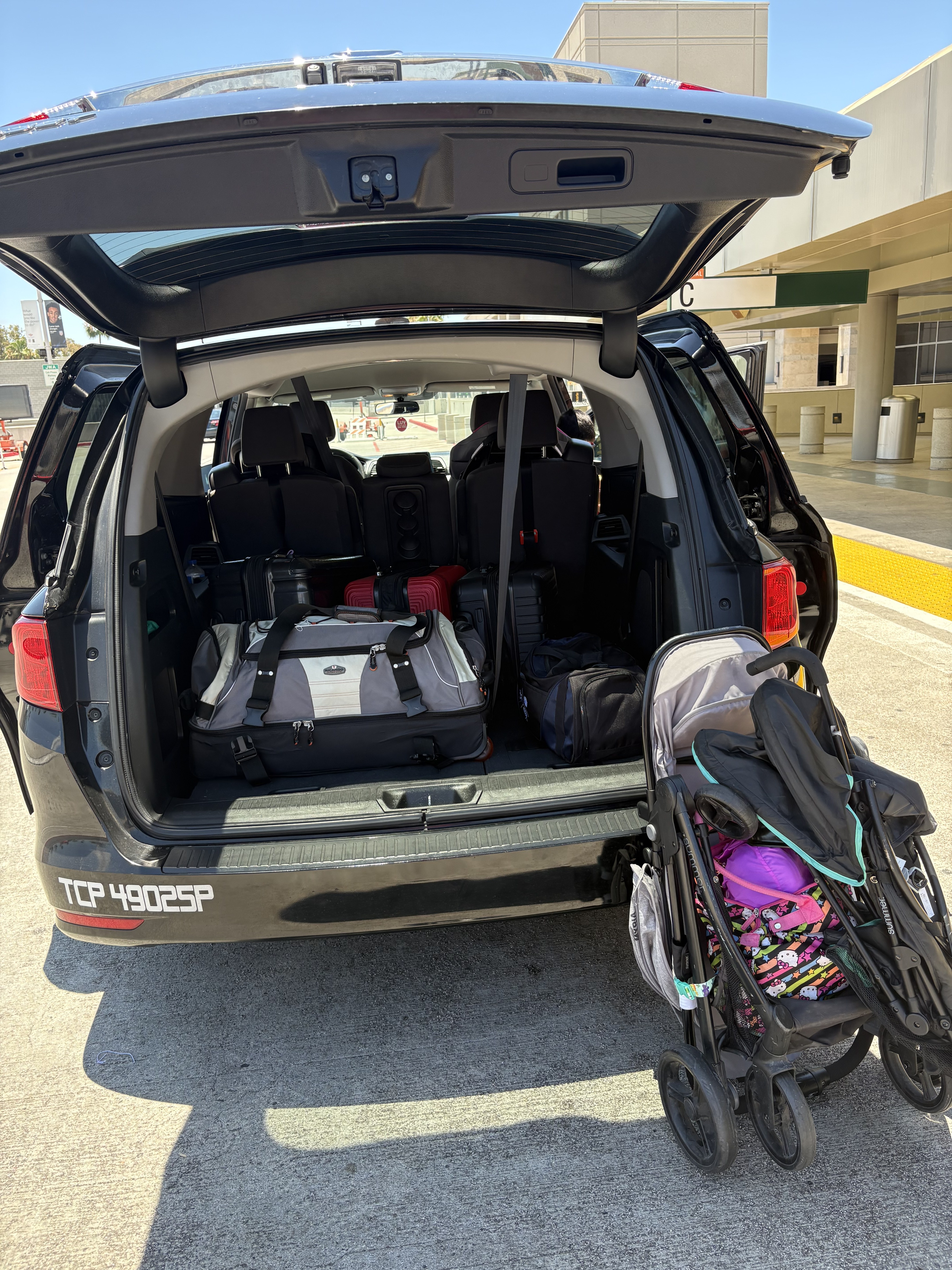City Cruze L.A. Honda Odyssey loaded with family luggage and a stroller at LAX, with TCP 49025-P visible