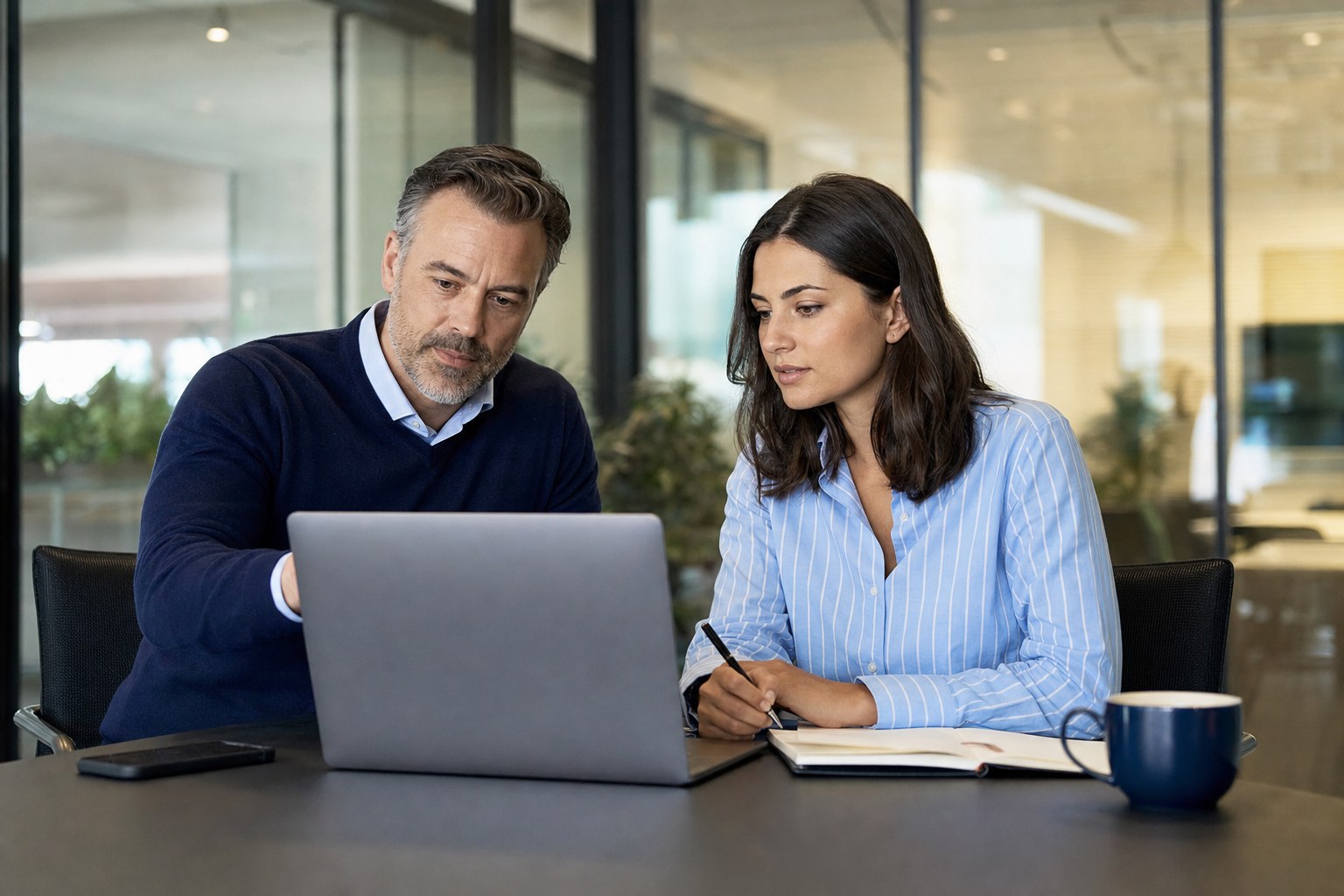 Sales manager and representative reviewing a customer call together
