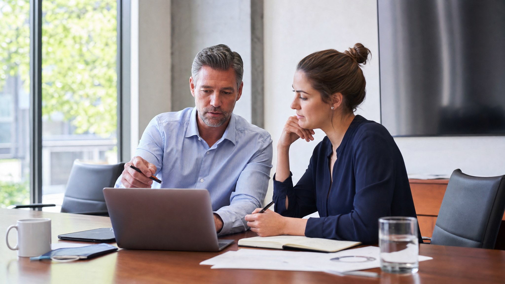 Sales manager coaching a new representative through a customer conversation review