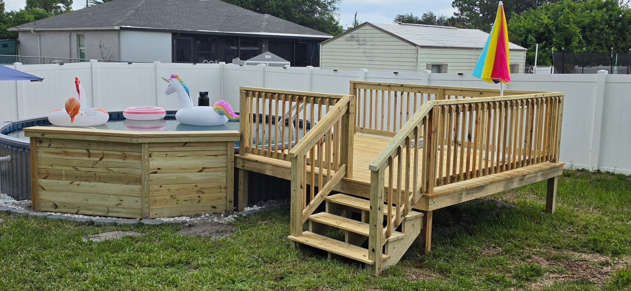 Custom wood pool deck with stairs and safety railing
