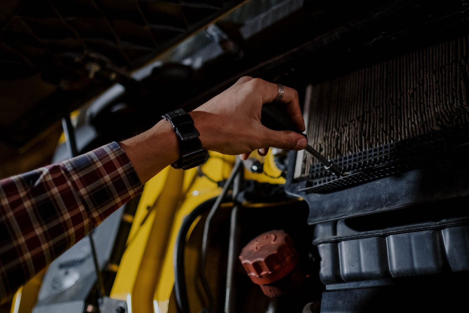 Buyer checking the engine area of a used vehicle before purchase