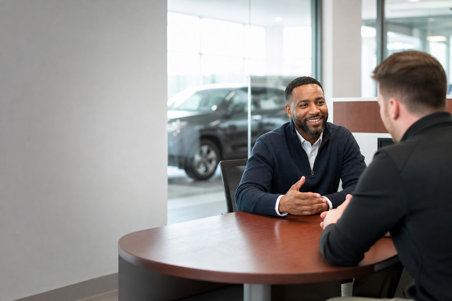 Two automotive dealership professionals discussing finance department solutions