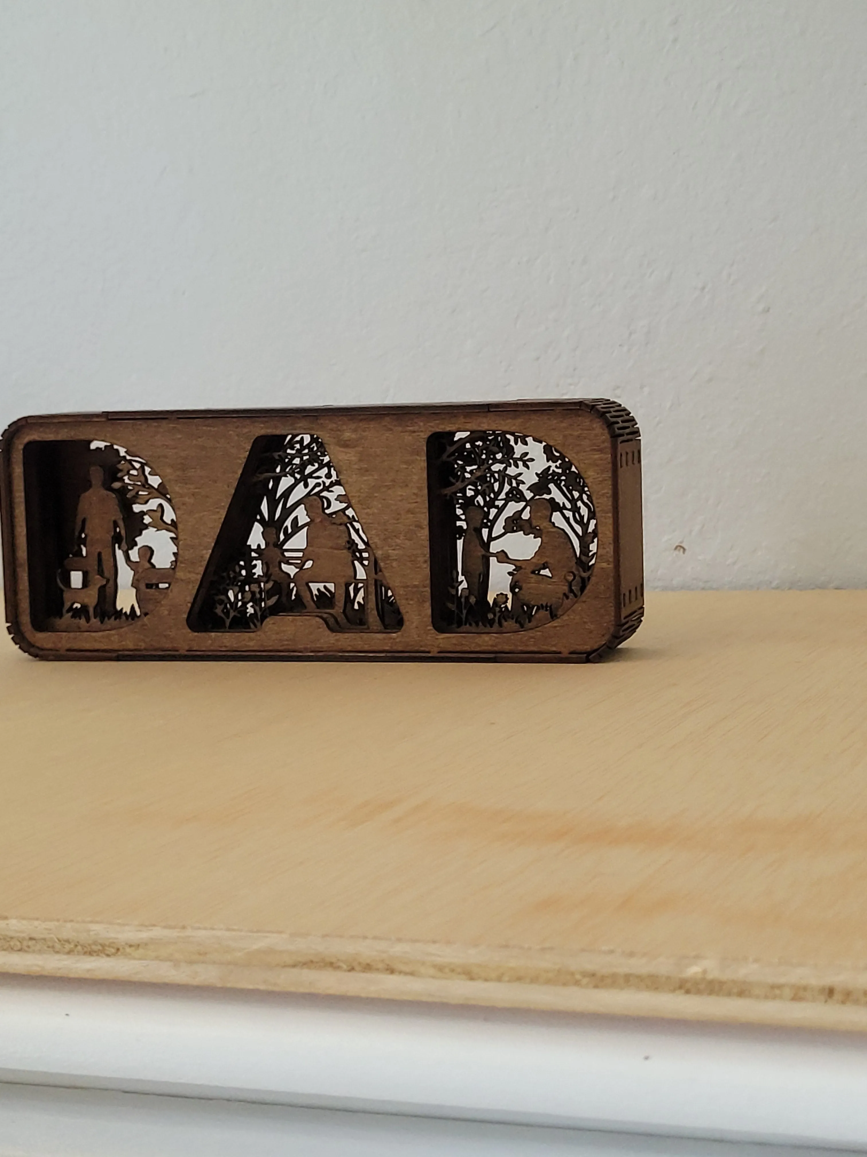 Close view of a layered handmade wood Dad Shadow Box