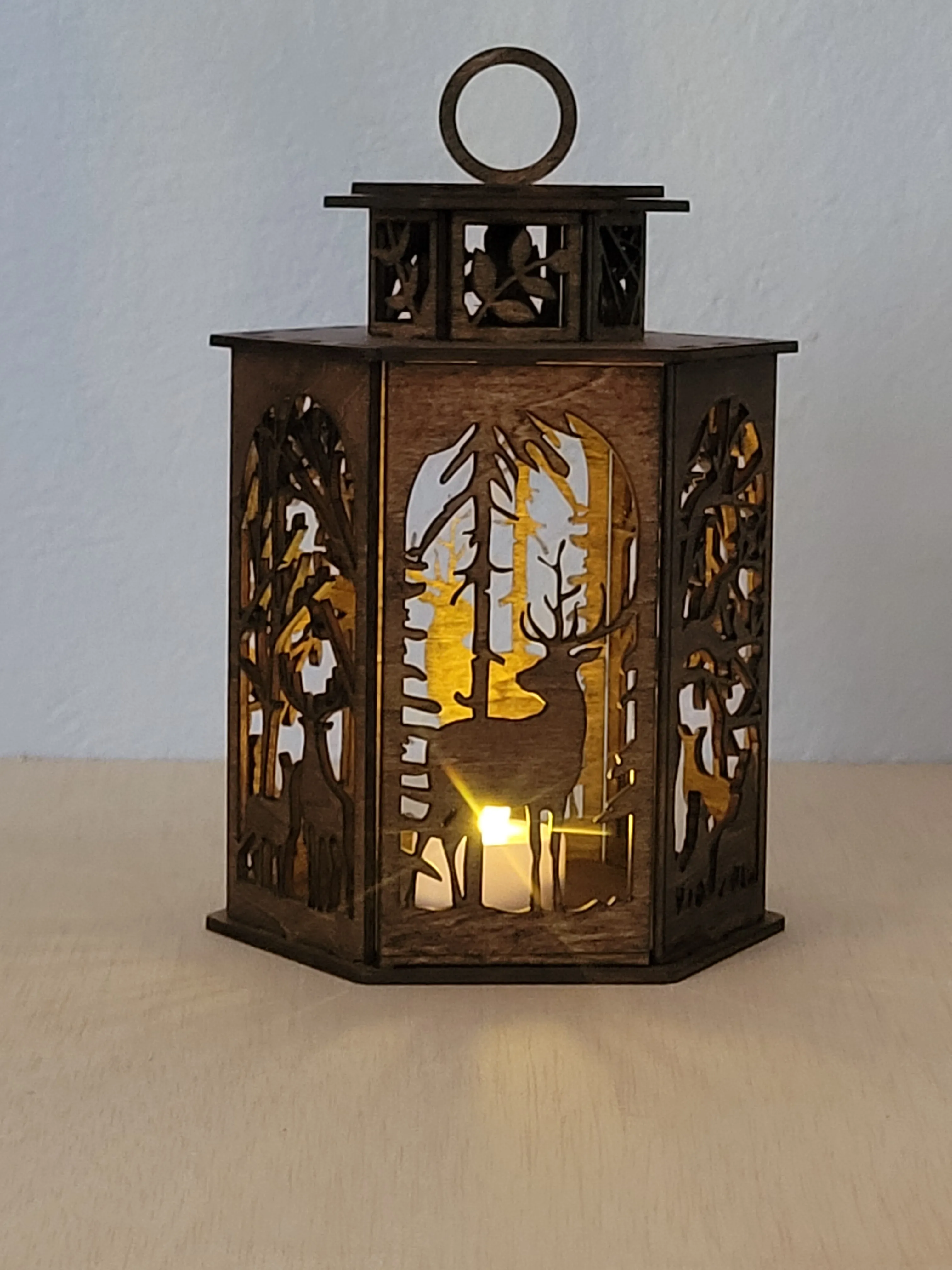 Laser-cut wood lamp adding a warm glow to a favourite room
