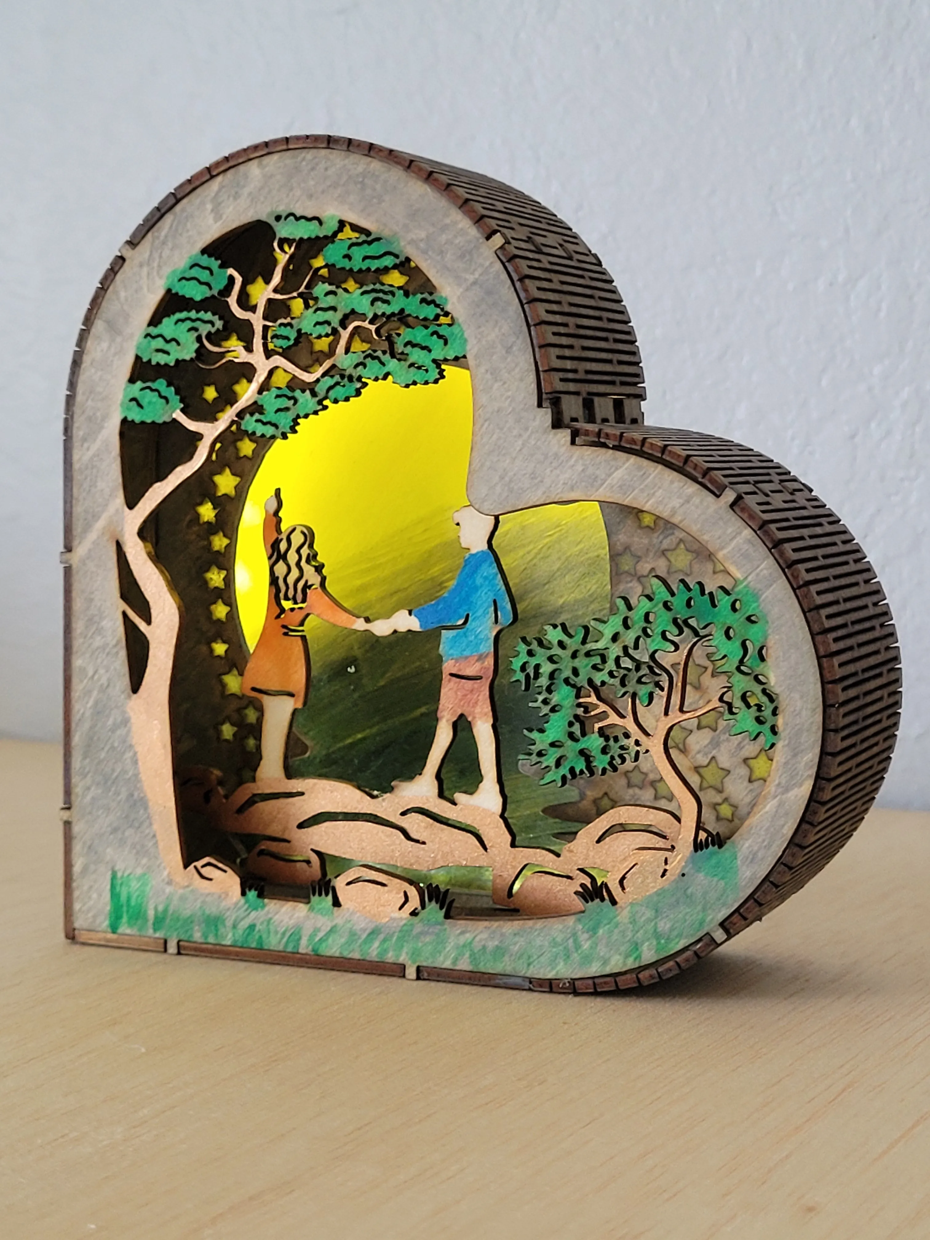 Close view of the layered details in a heart-shaped wood shadow box