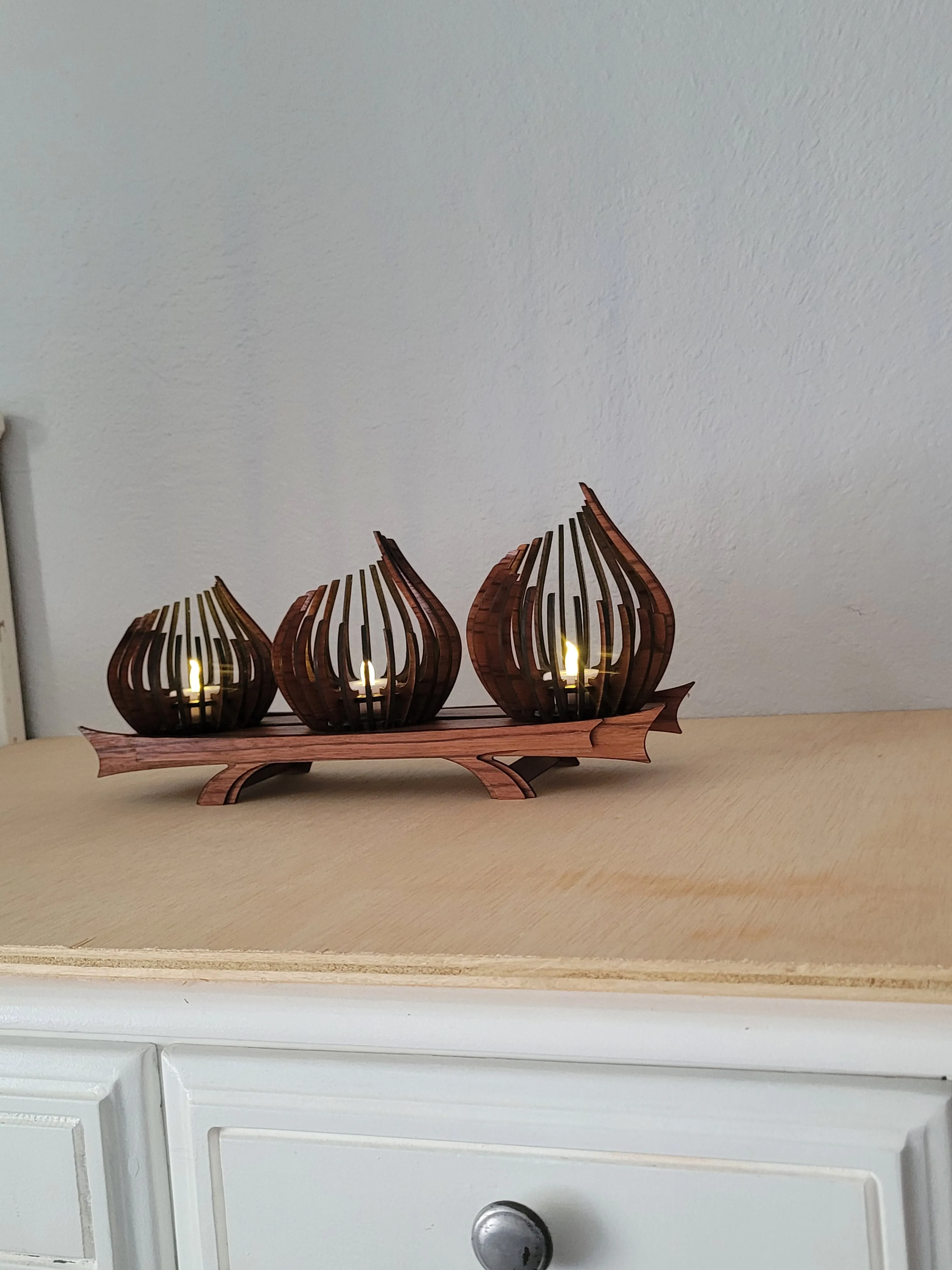 Hand-finished wooden tea light candle holder with a warm stained finish