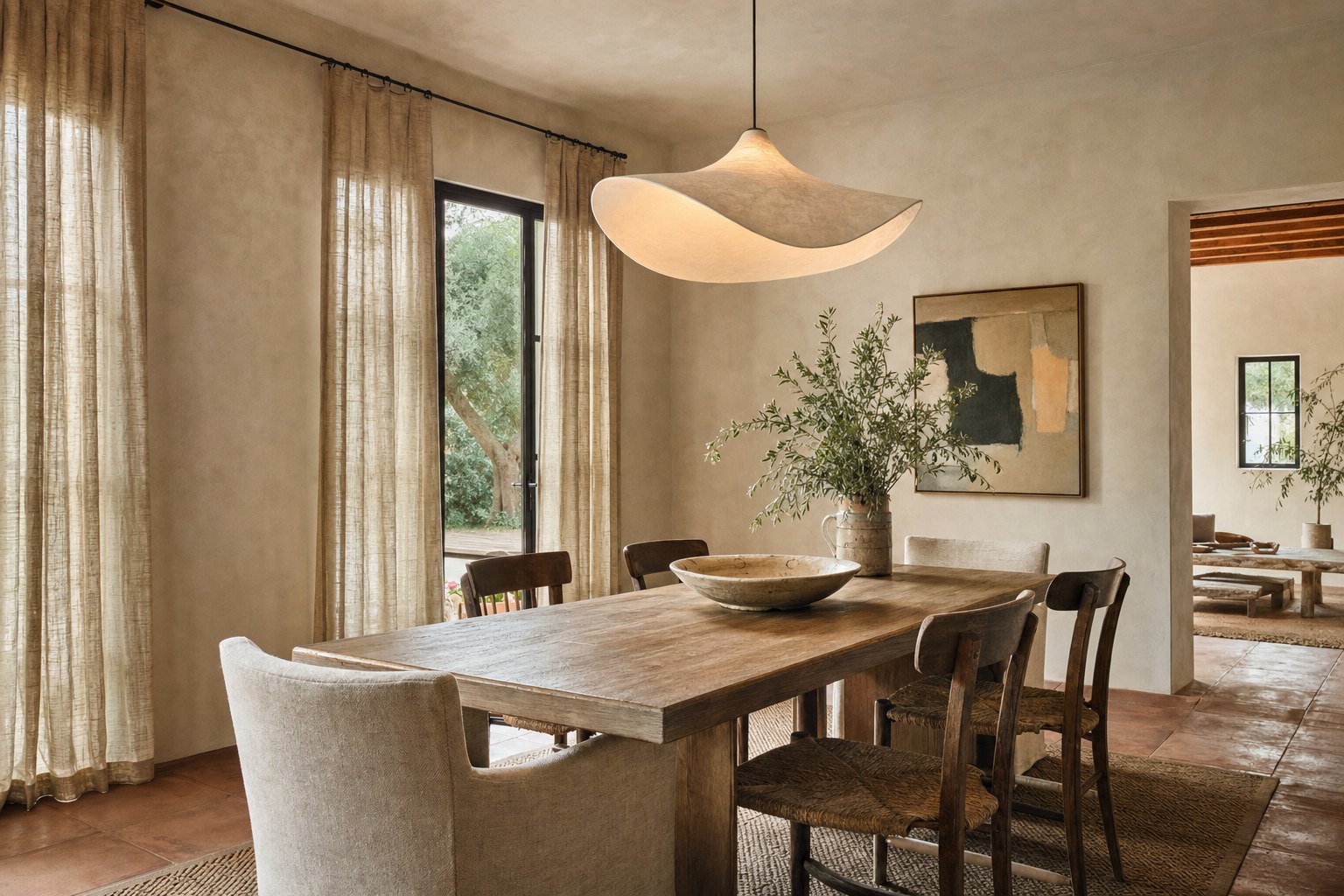 Vacation rental dining area with a sculptural pendant and a table set for guests