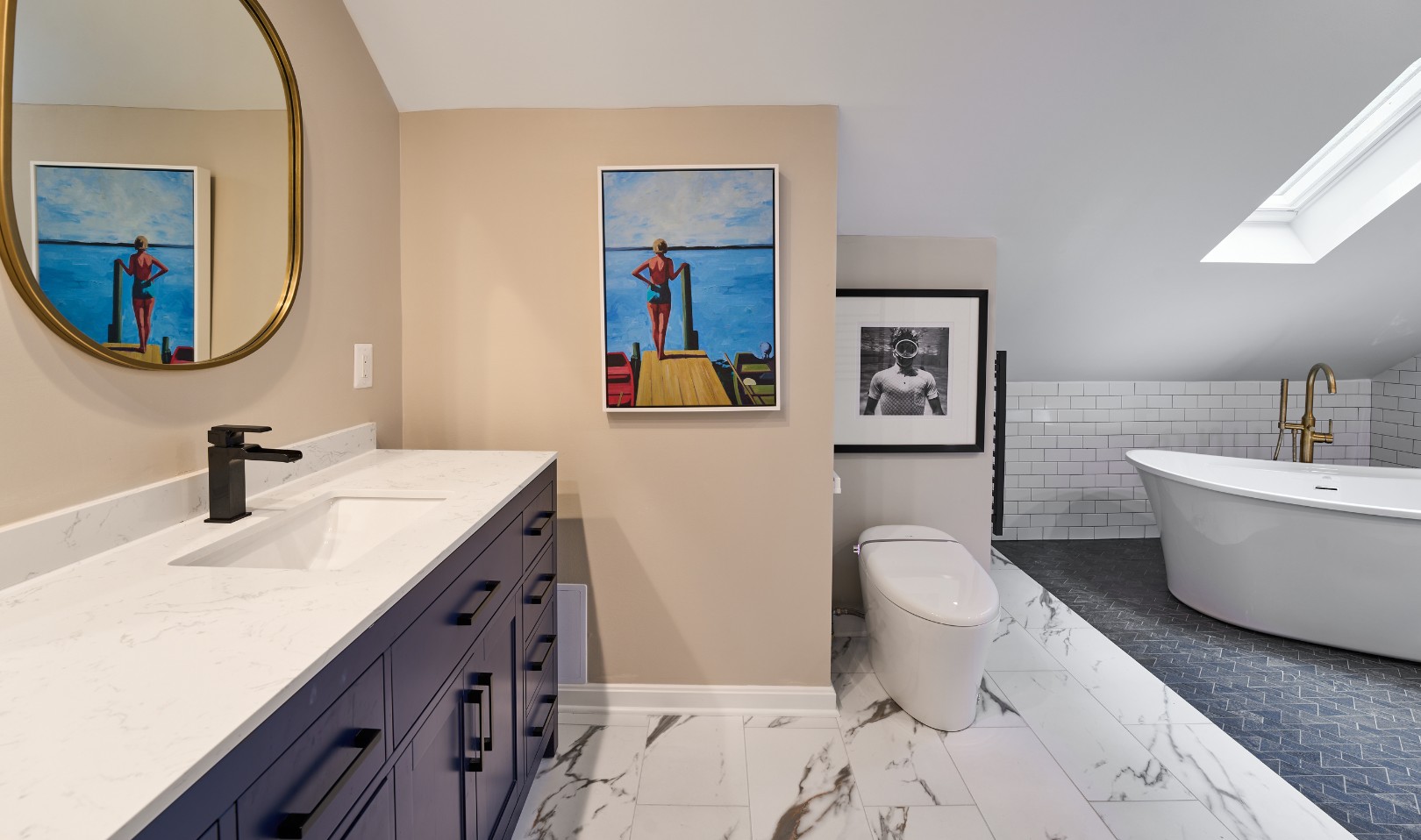 Bathroom with navy vanity and freestanding tub by Kerry Leikus Designs