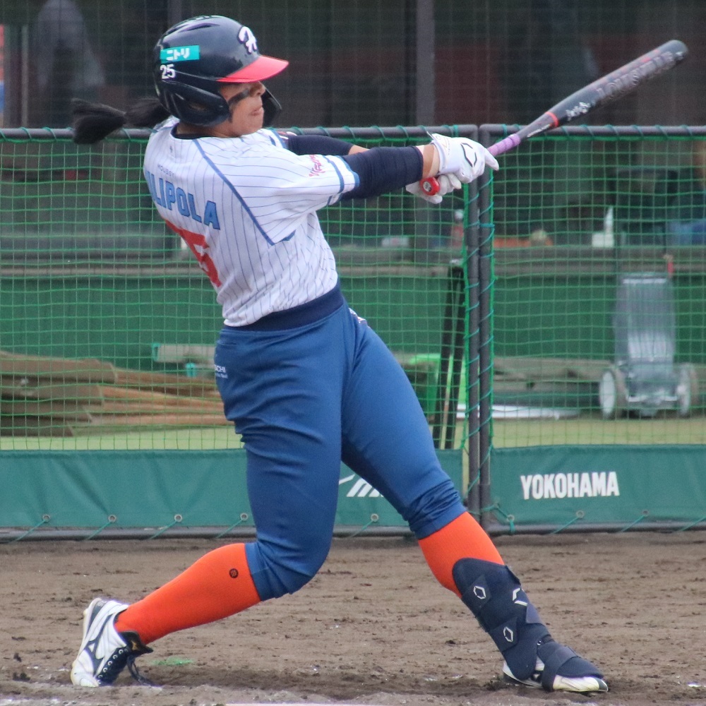Softball player swinging a bat during a game