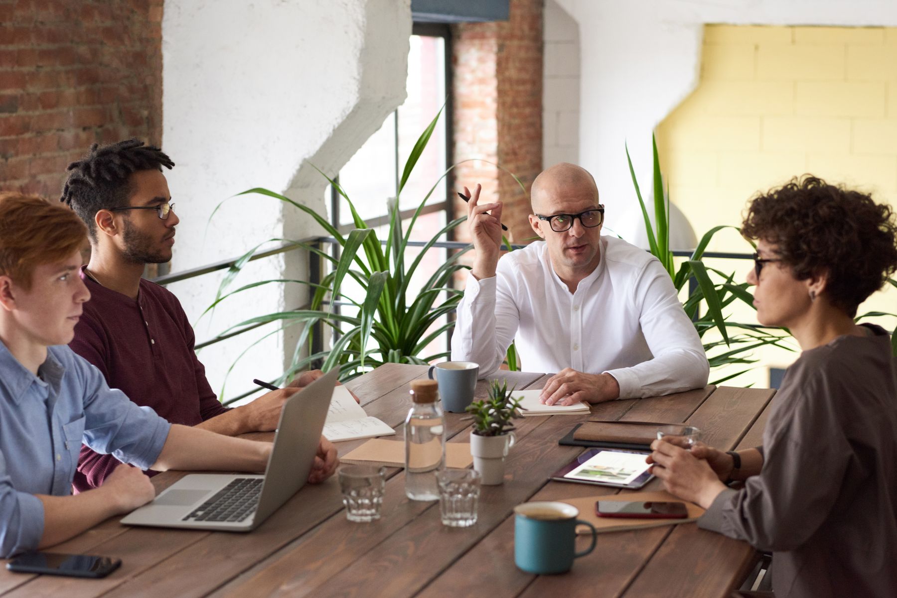 Leadership team in a working discussion around a table
