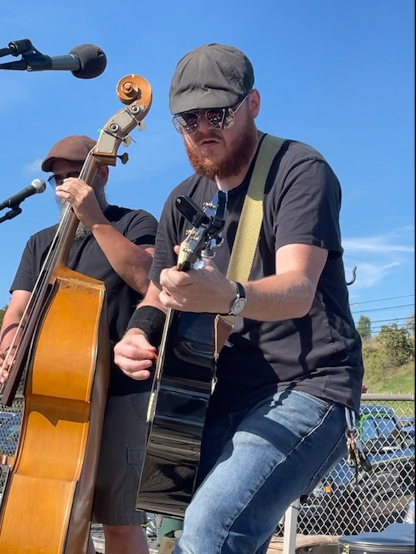 Guitarist and upright bassist performing outdoors with the original Right TurnClyde