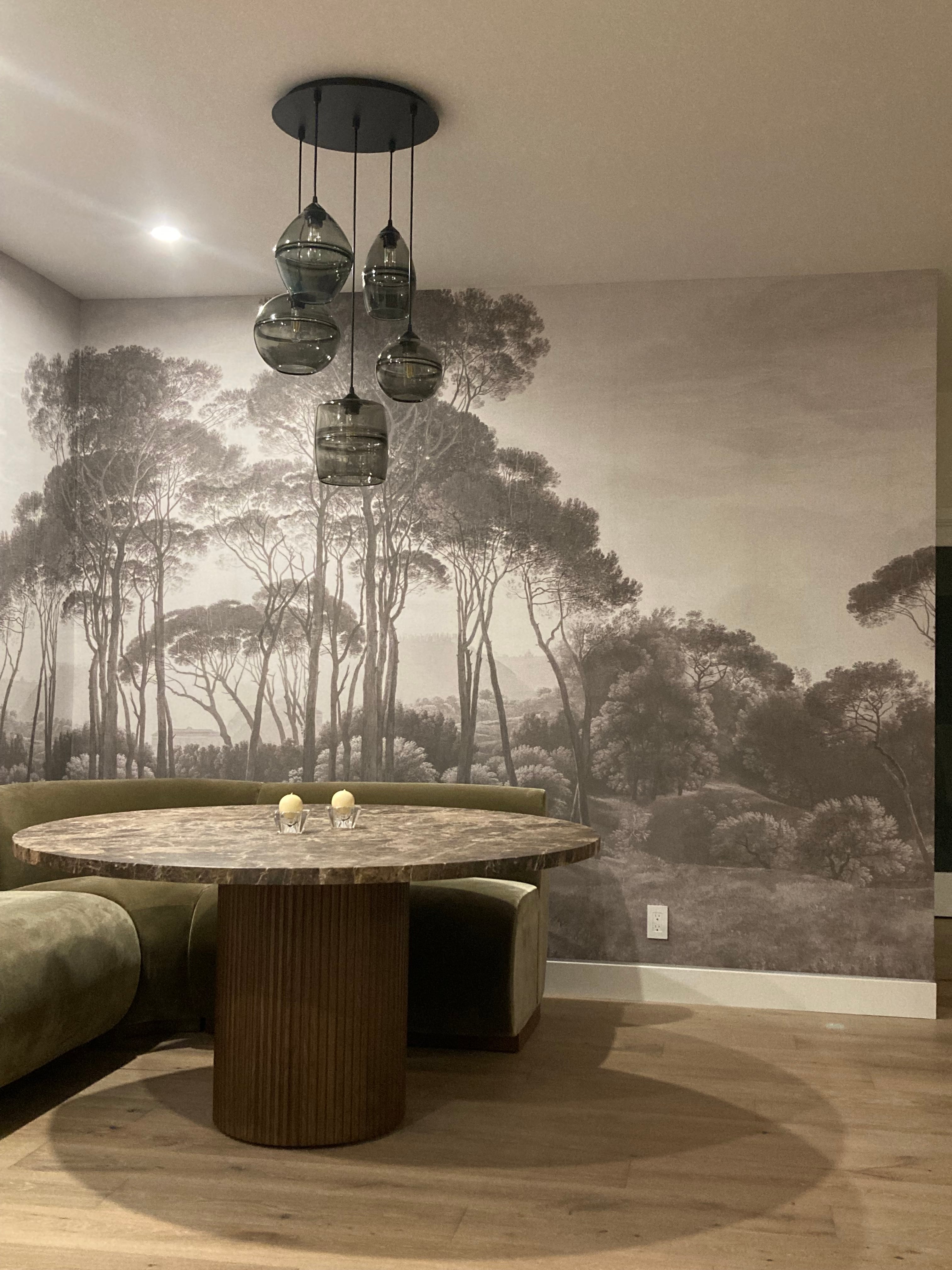 Finished dining room with a landscape wallpaper mural