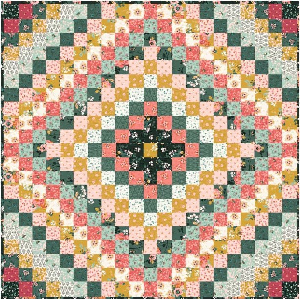 Finished patchwork quilt in green, coral, cream, and gold