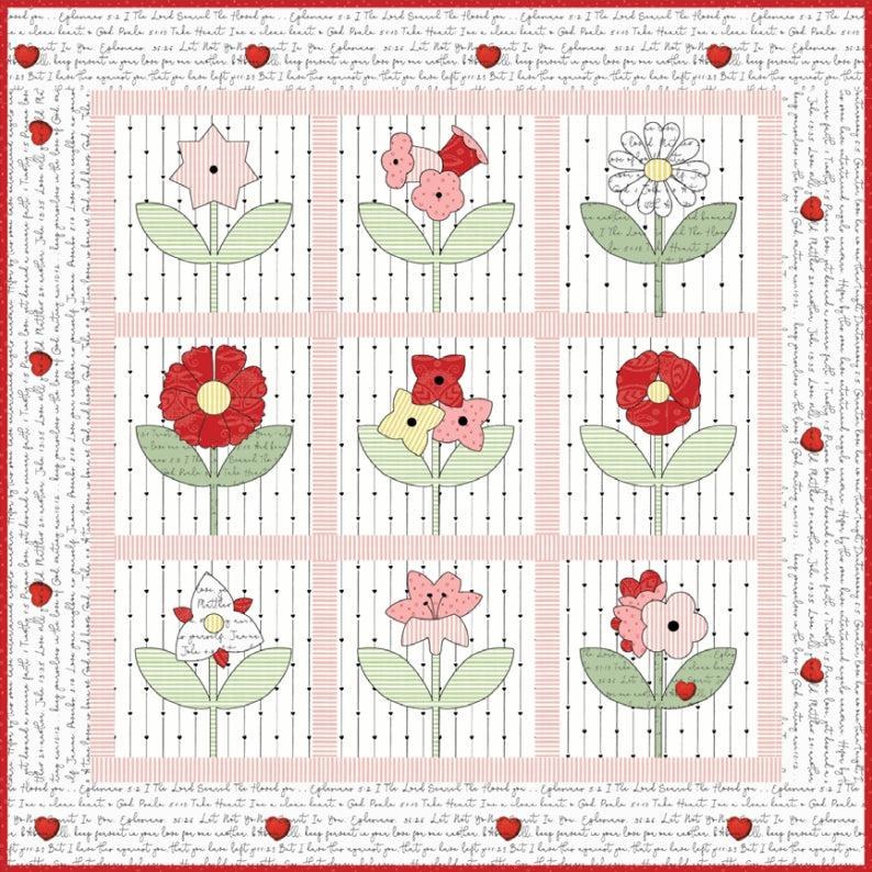 Patchwork quilt with floral blocks in soft pink, green, and red