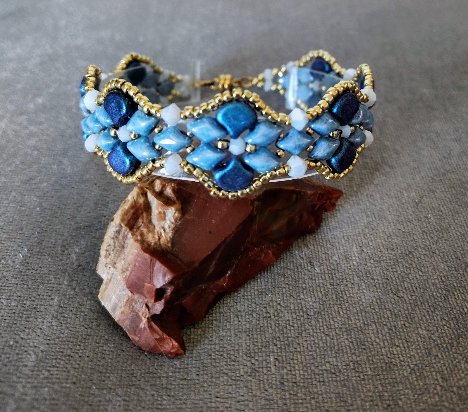 Blueberry Blues Bracelet displayed over a red stone