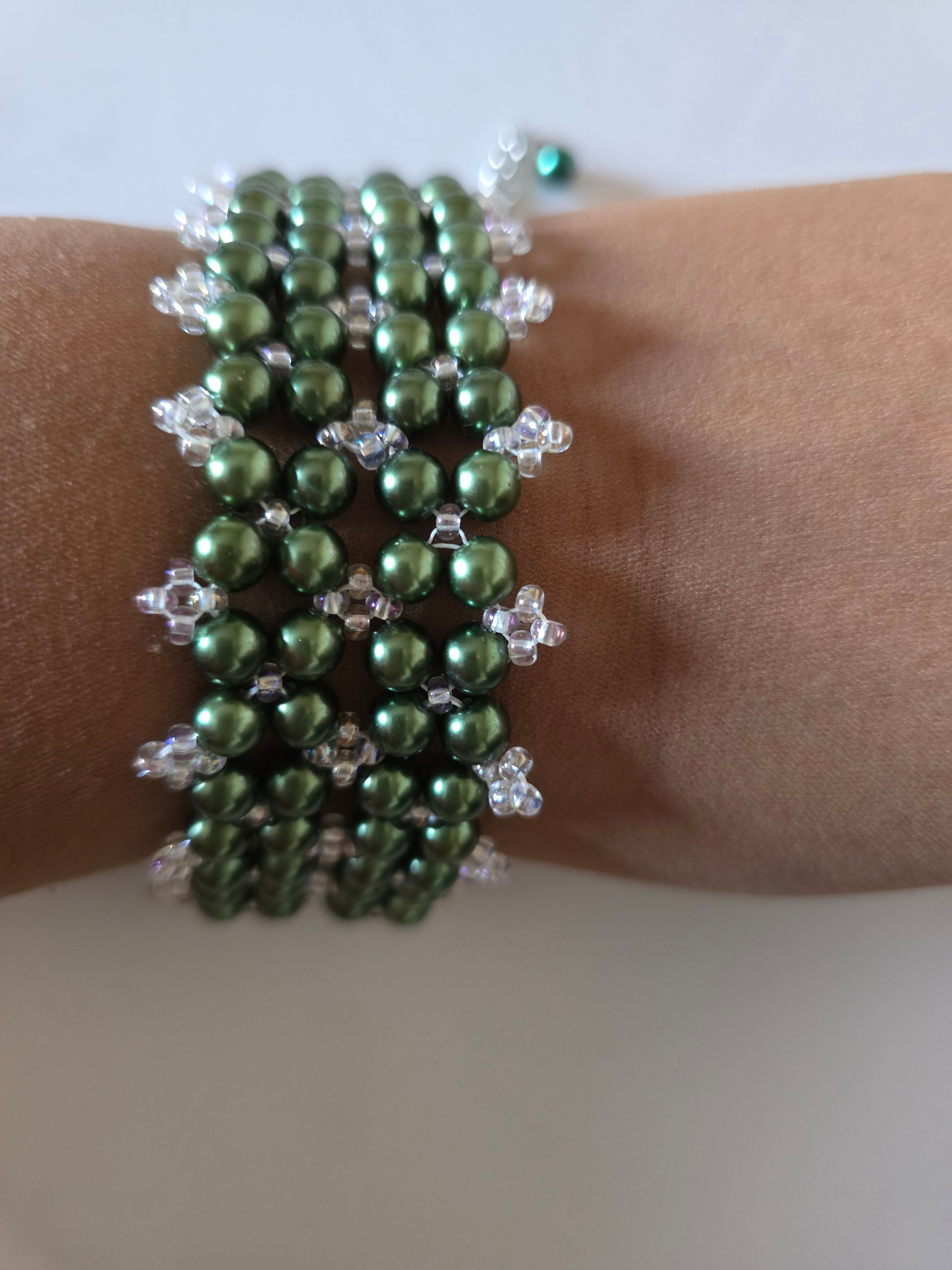 Forest Canopy green glass pearl cuff bracelet worn on a wrist