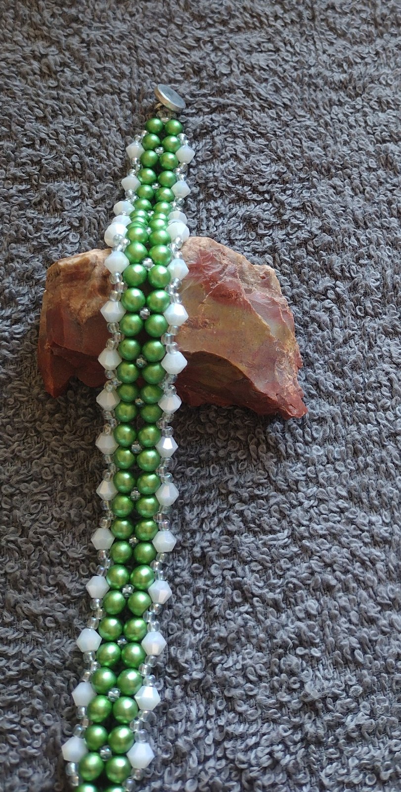 Matte Green Pearl and Jade Bicone Bracelet photographed upright