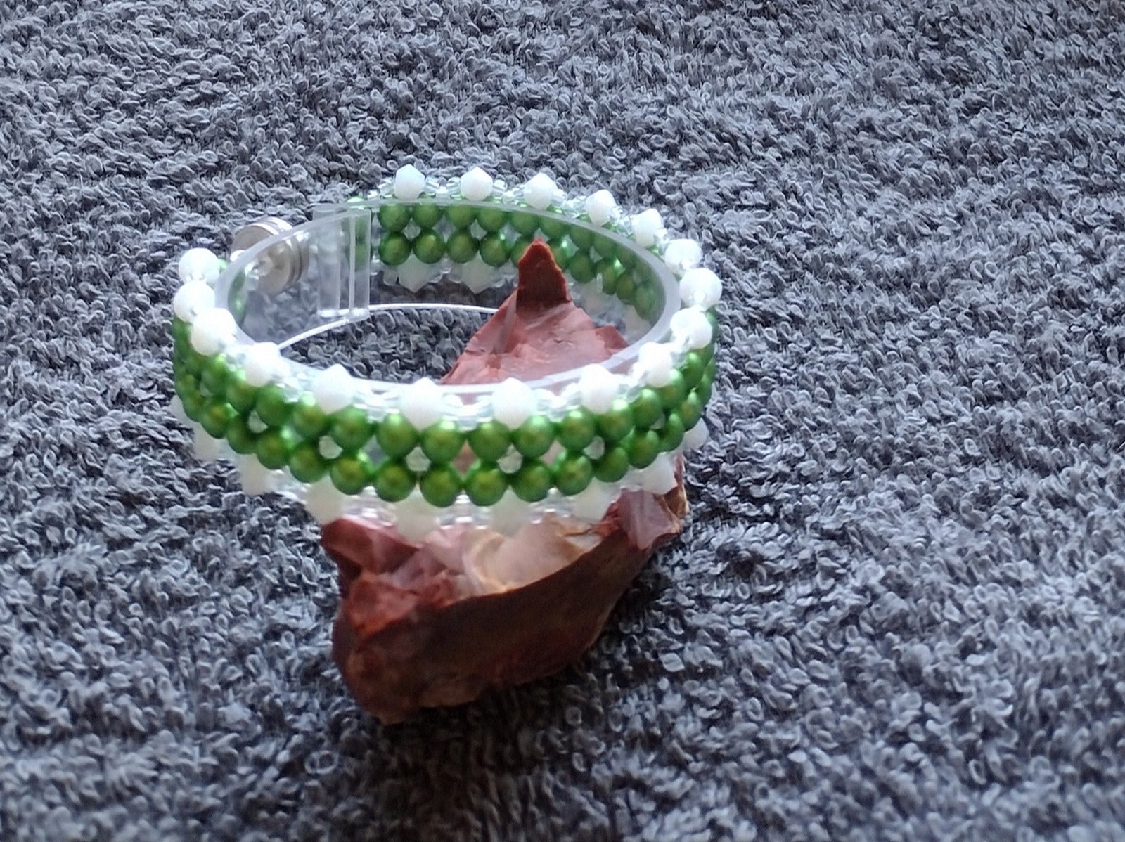 Matte Green Pearl and Jade Bicone Bracelet laid flat