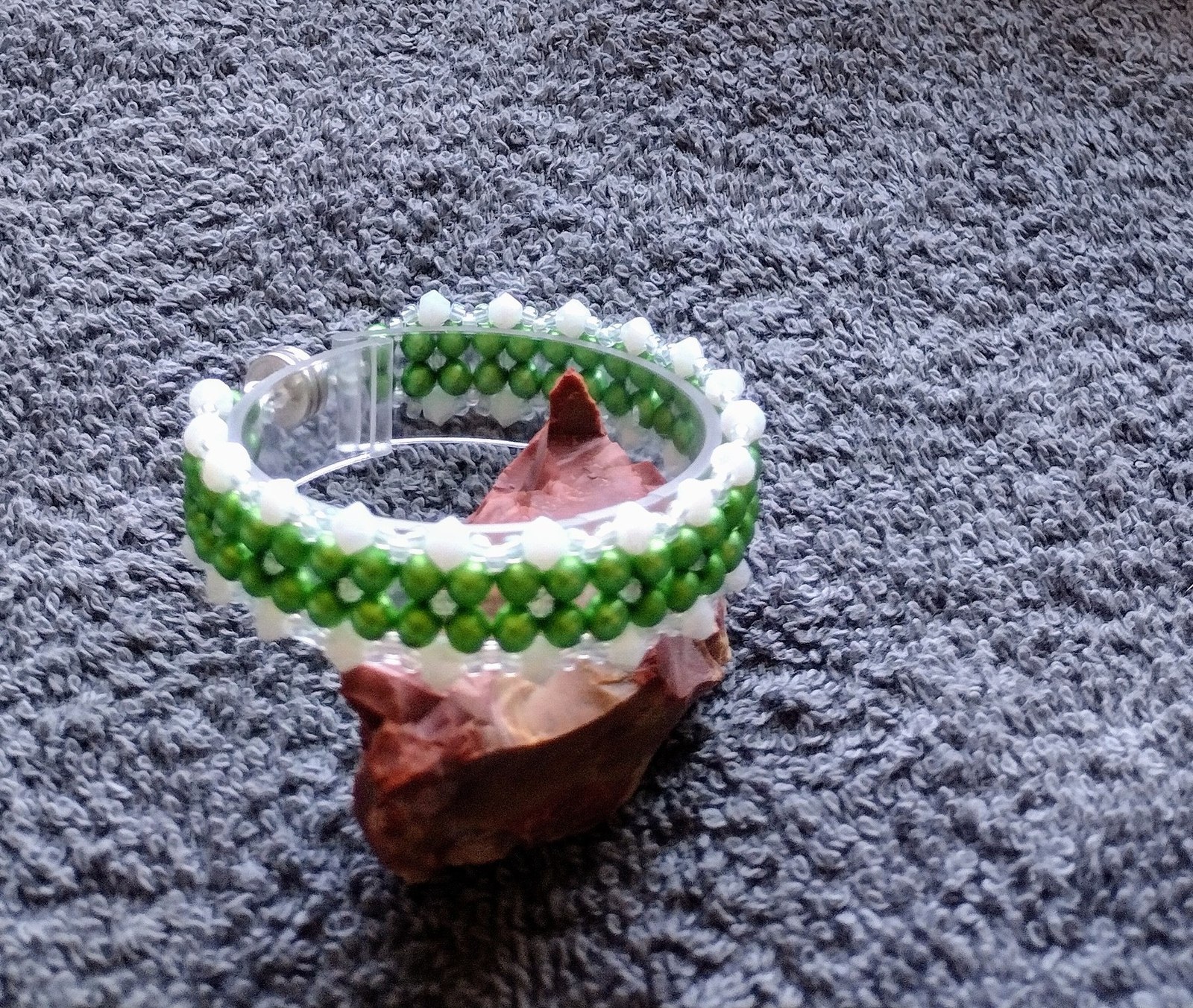 Close view of the matte green pearl and jade beadwork