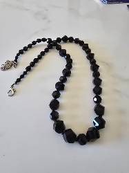 Full length of Midnight Sparkle black faceted-bead necklace with its adjustable clasp