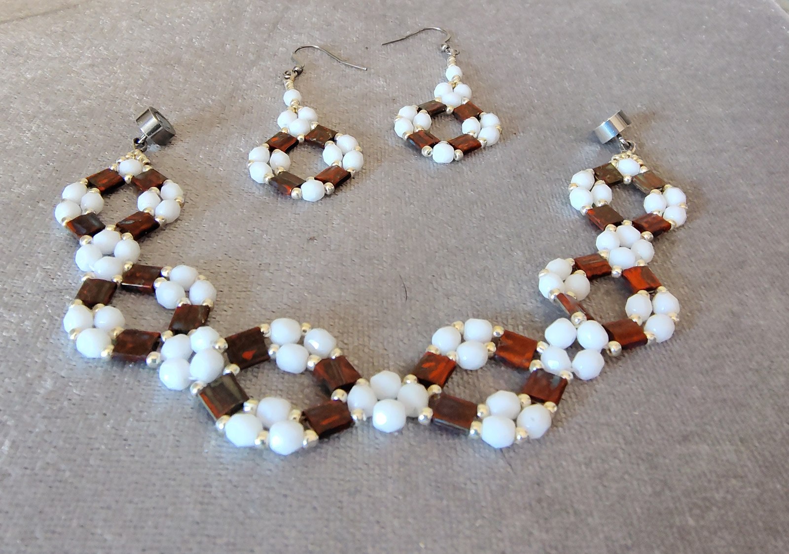 Picasso Red Tila bracelet and earrings on gray fabric