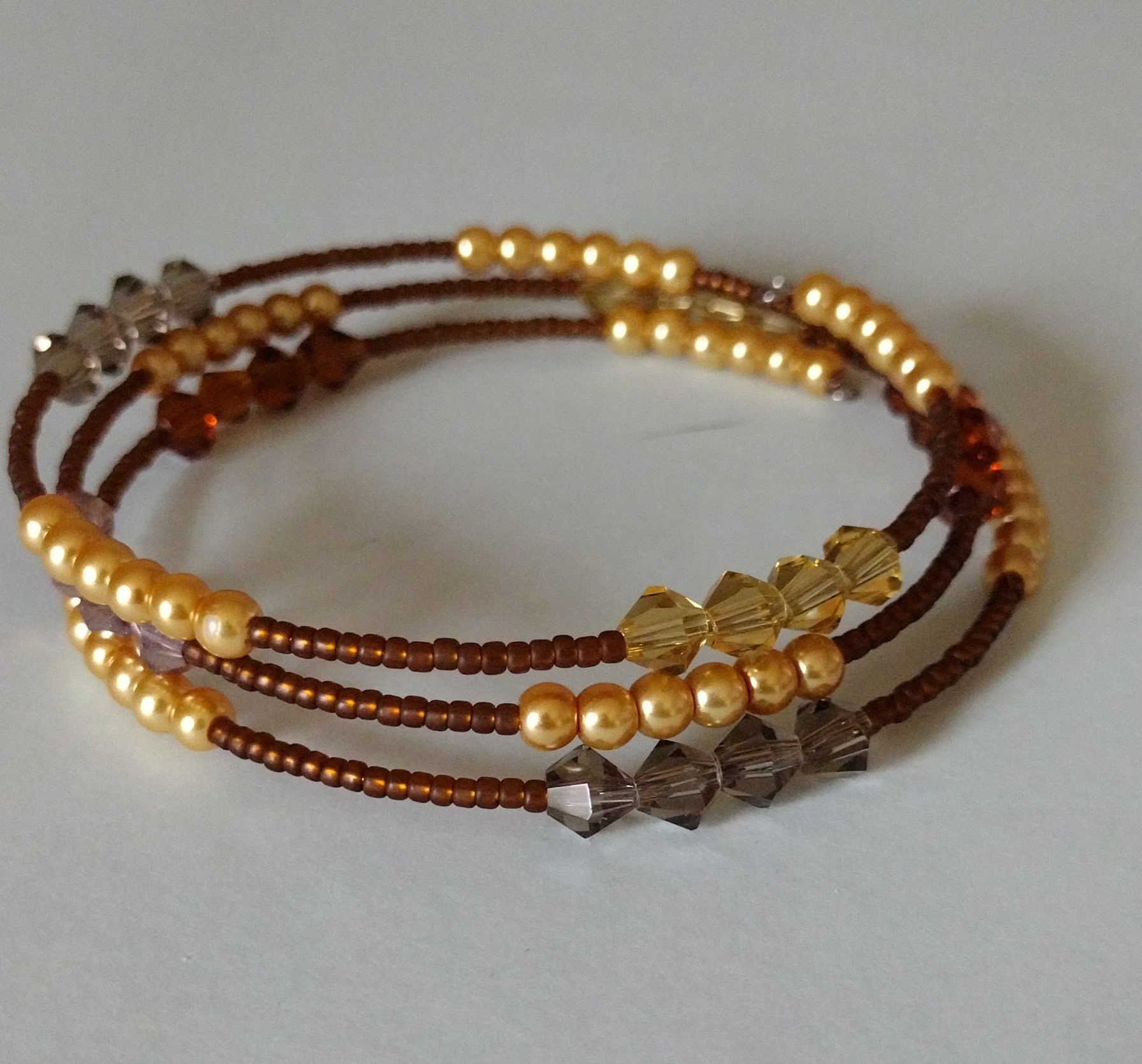 Close view of the Rootbeer memory-wire bangle beadwork